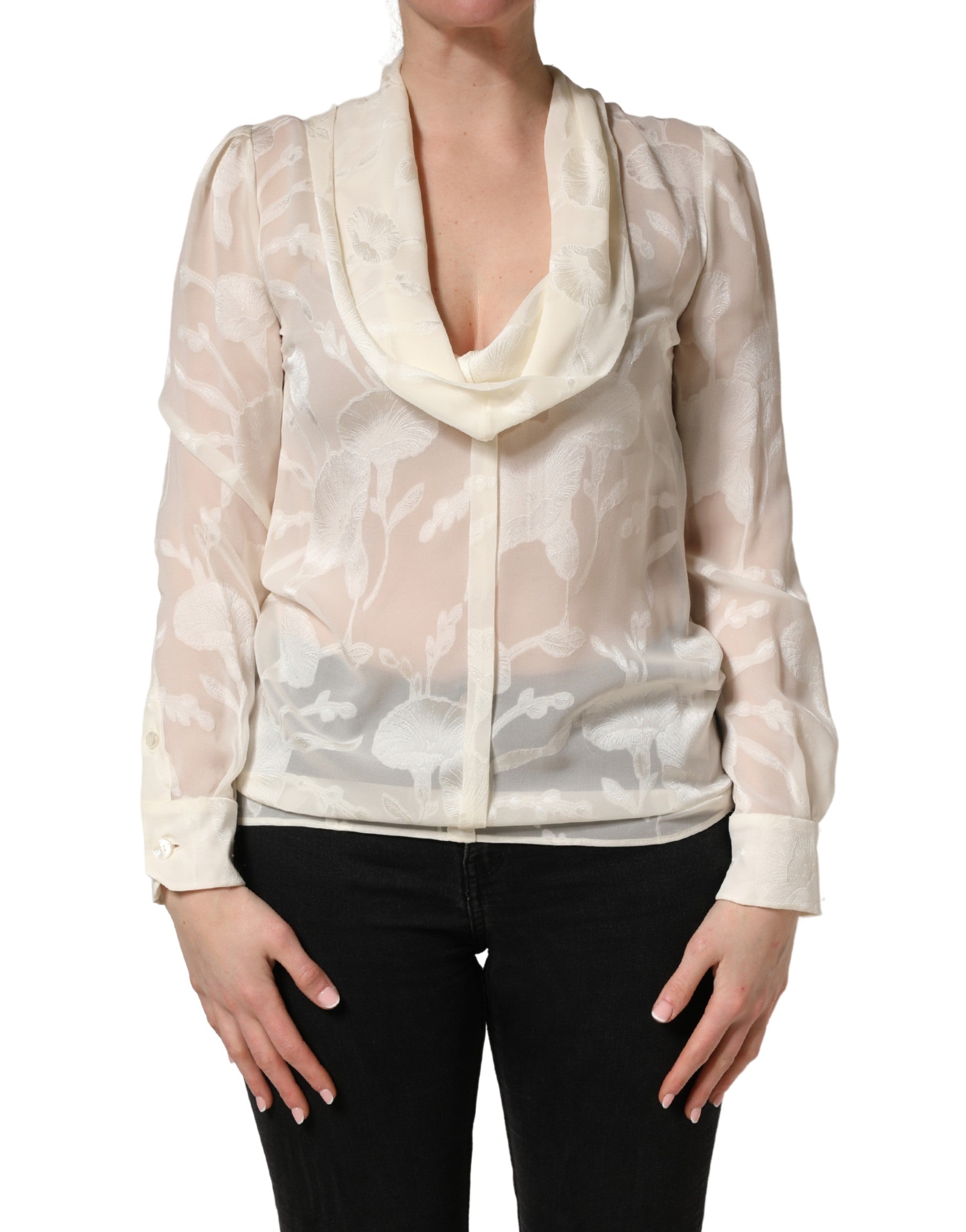 Elevate your wardrobe with the Dolce & Gabbana Off White Floral Semi Sheer Silk Blouse, a masterpiece of Italian craftsmanship that embodies timeless elegance and sophistication.