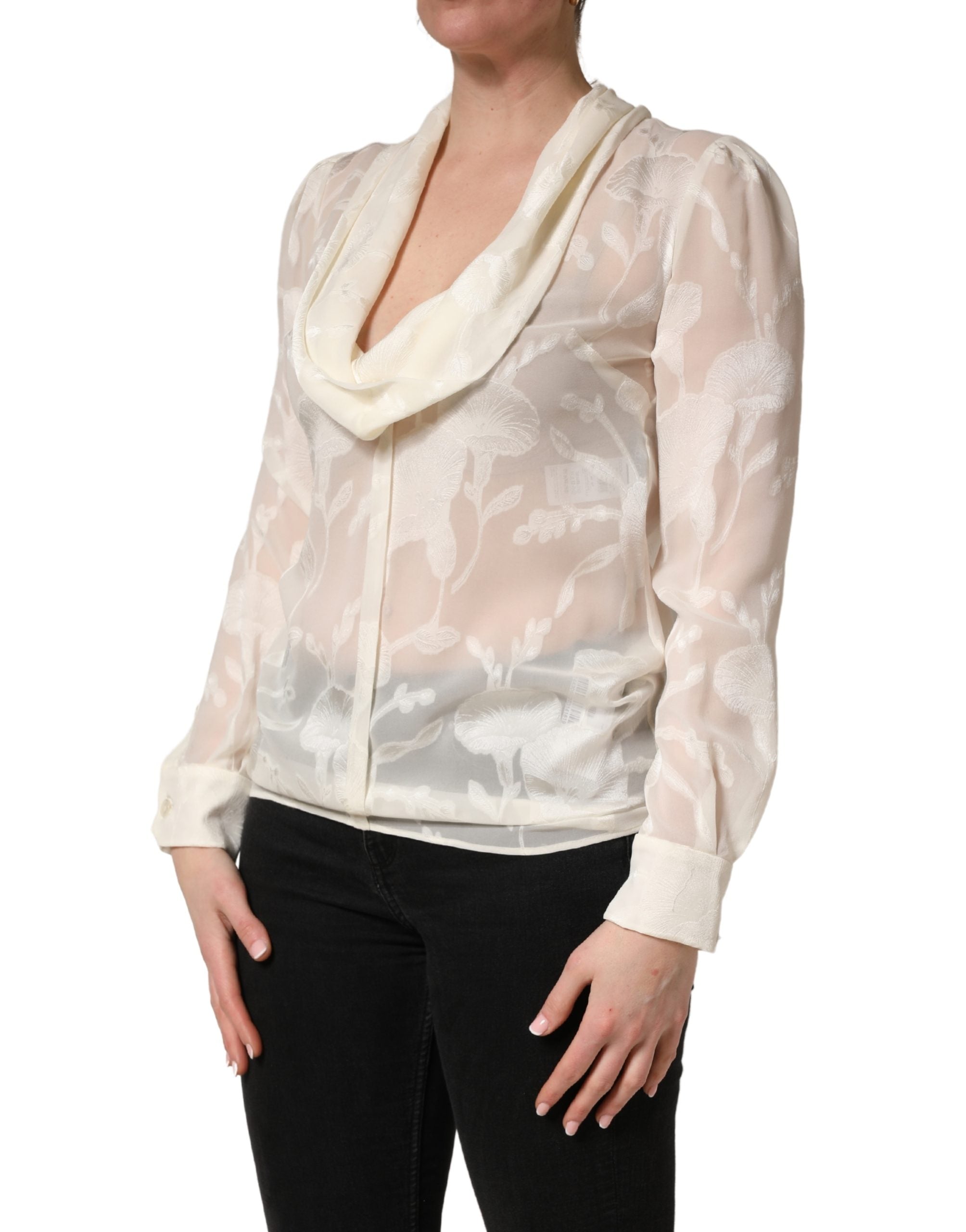 Elevate your wardrobe with the Dolce & Gabbana Off White Floral Semi Sheer Silk Blouse, a masterpiece of Italian craftsmanship that embodies timeless elegance and sophistication.