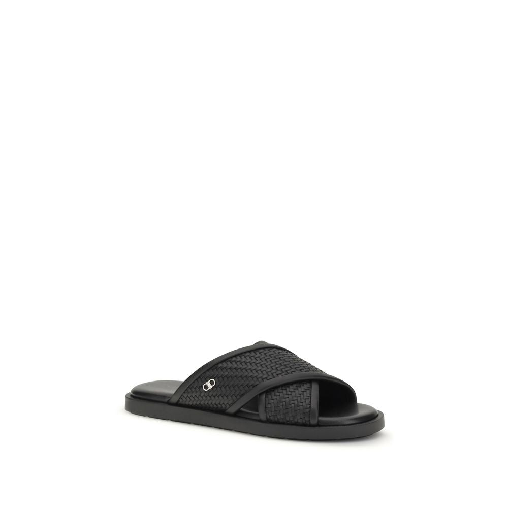 Elevate your style with Ferragamo Black Calf Leather Bos Taurus Flat Sandals, where exquisite craftsmanship meets timeless luxury for unparalleled sophistication.