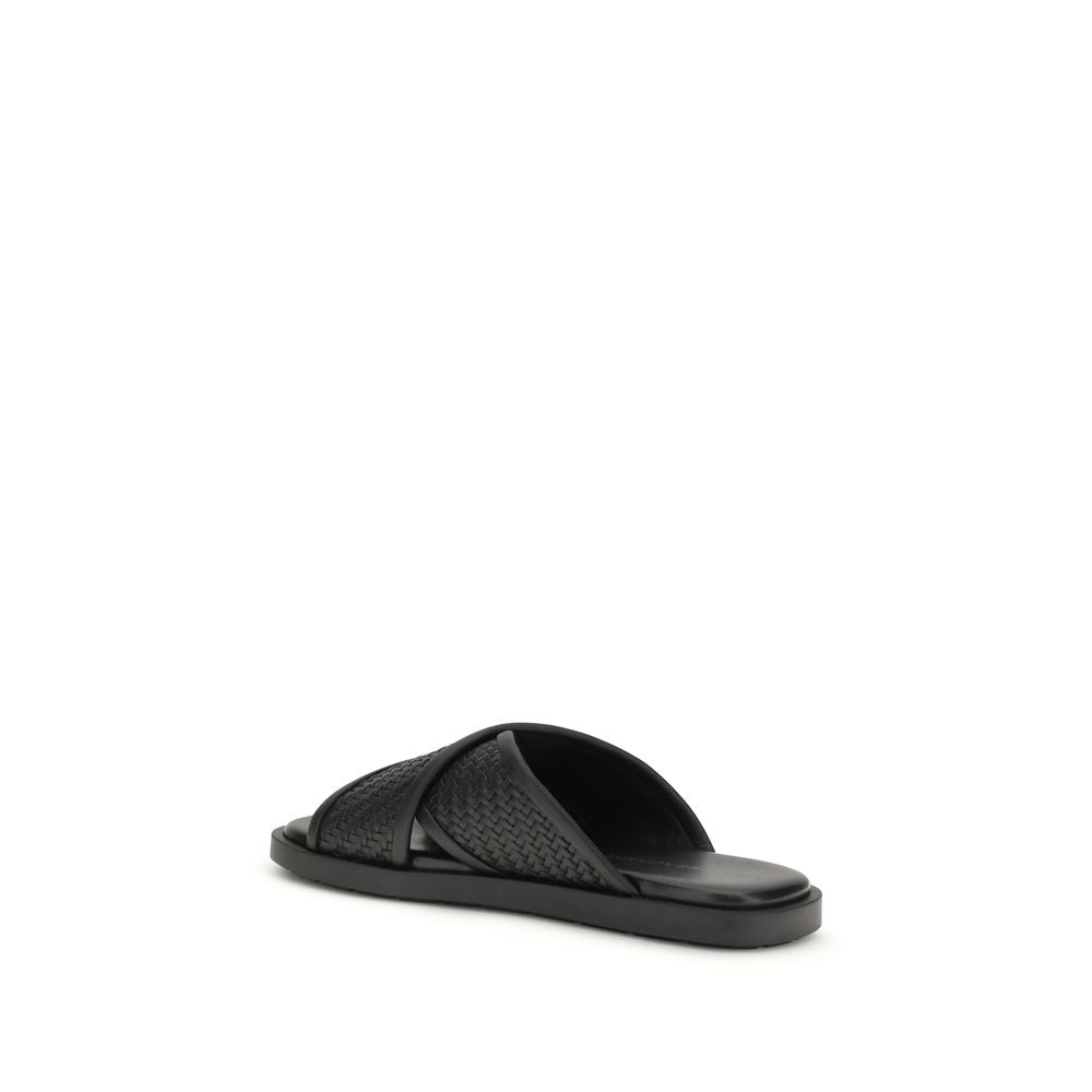 Elevate your style with Ferragamo Black Calf Leather Bos Taurus Flat Sandals, where exquisite craftsmanship meets timeless luxury for effortless sophistication.