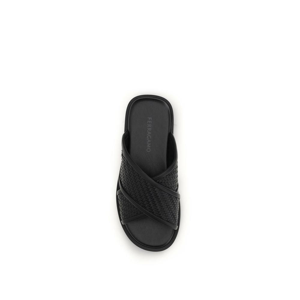 Indulge in the Ferragamo Black Calf Leather Bos Taurus Flat Sandals, where exquisite craftsmanship meets timeless luxury for a sophisticated lifestyle.