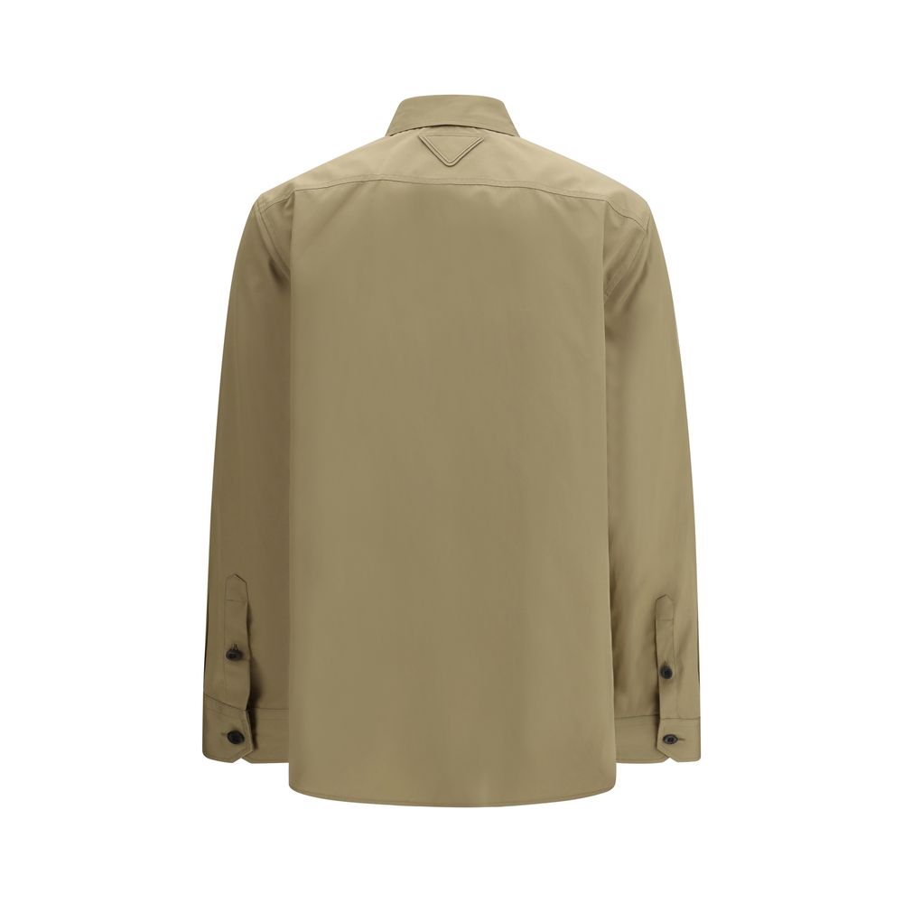 Elevate your wardrobe with the Prada Beige Cotton Shirt, a masterpiece of tailored precision and utilitarian elegance, crafted for the discerning fashion connoisseur.