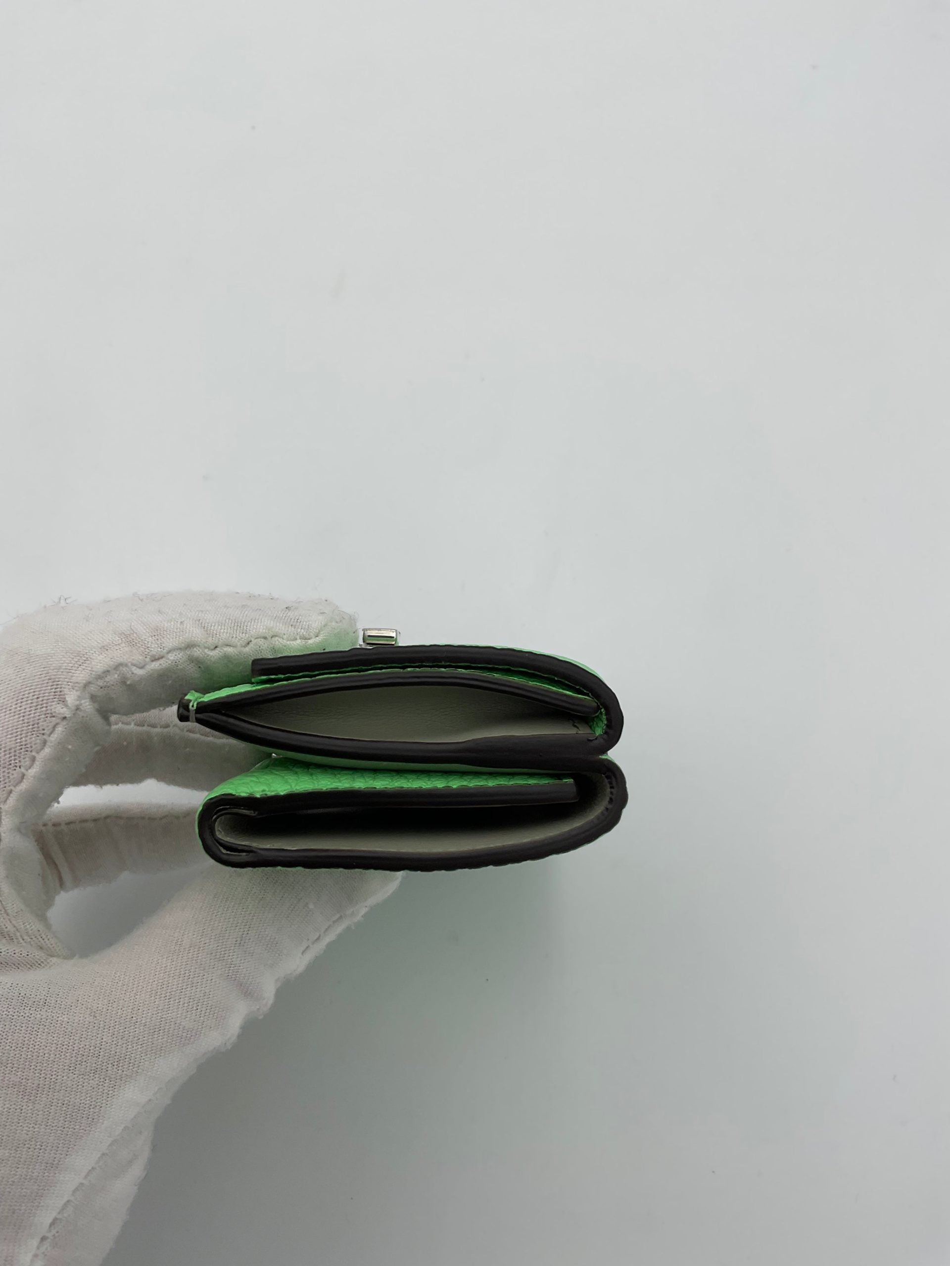 Discover the Fendi PEEKABOO Small Wallet, a luxurious blend of Roman and calf leather, embodying timeless elegance and exquisite craftsmanship for the discerning individual.