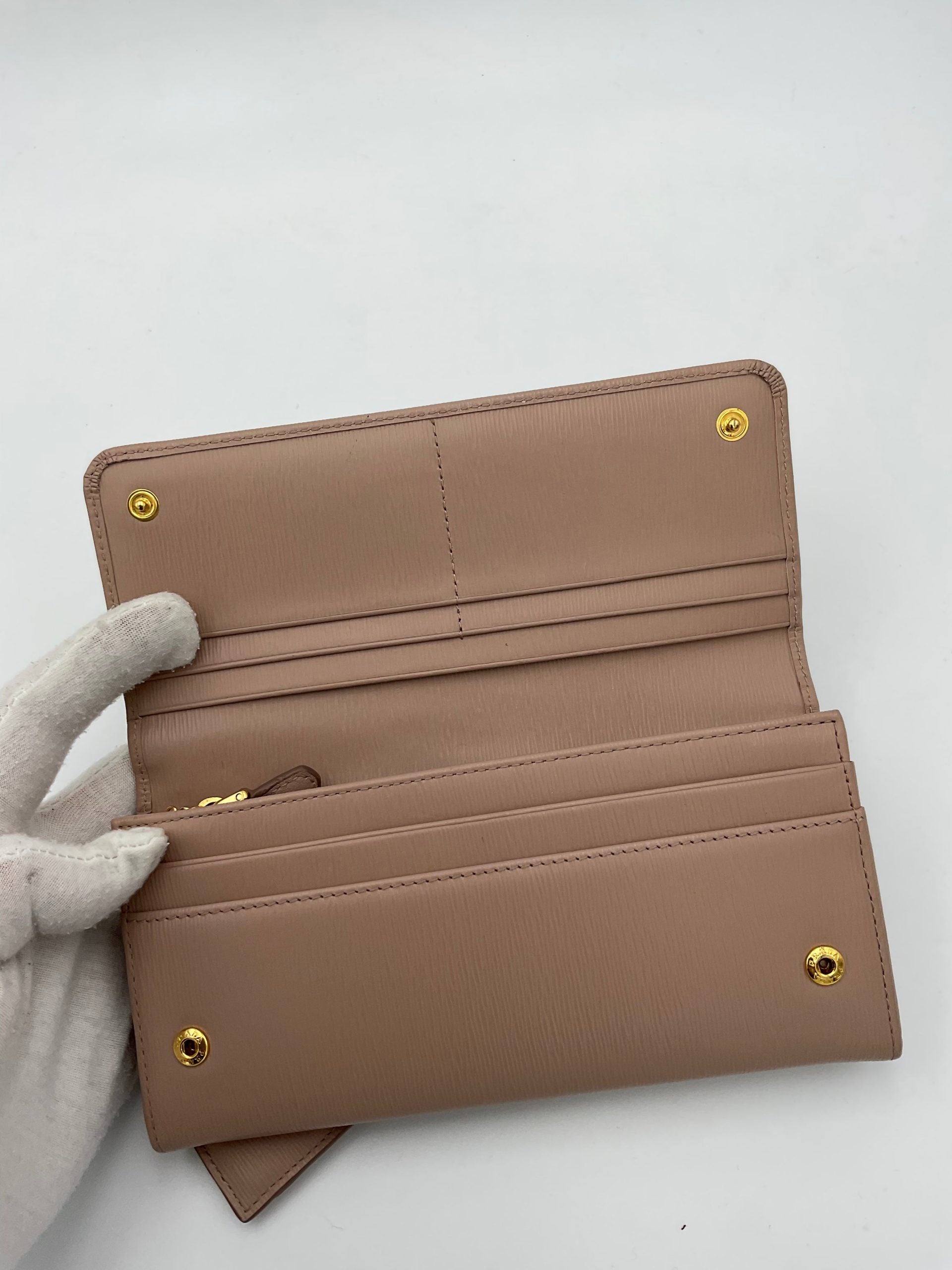 Discover the Prada PRADA Powder Saffiano Wallet, a masterpiece of luxury and craftsmanship, designed for those who appreciate elegance and sophistication.