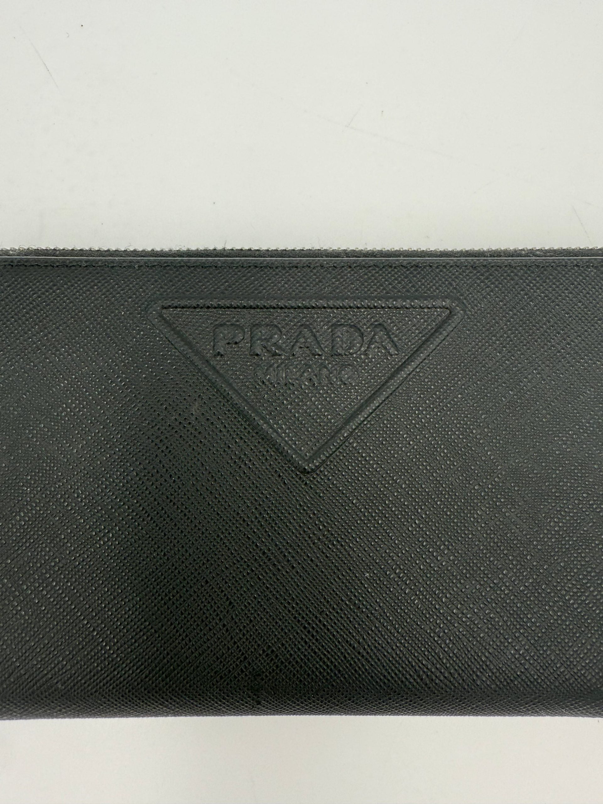 Indulge in the exquisite Prada PRADA Zip in Saffiano Leather Wallet, a symbol of refined luxury and impeccable craftsmanship, perfect for the discerning connoisseur.