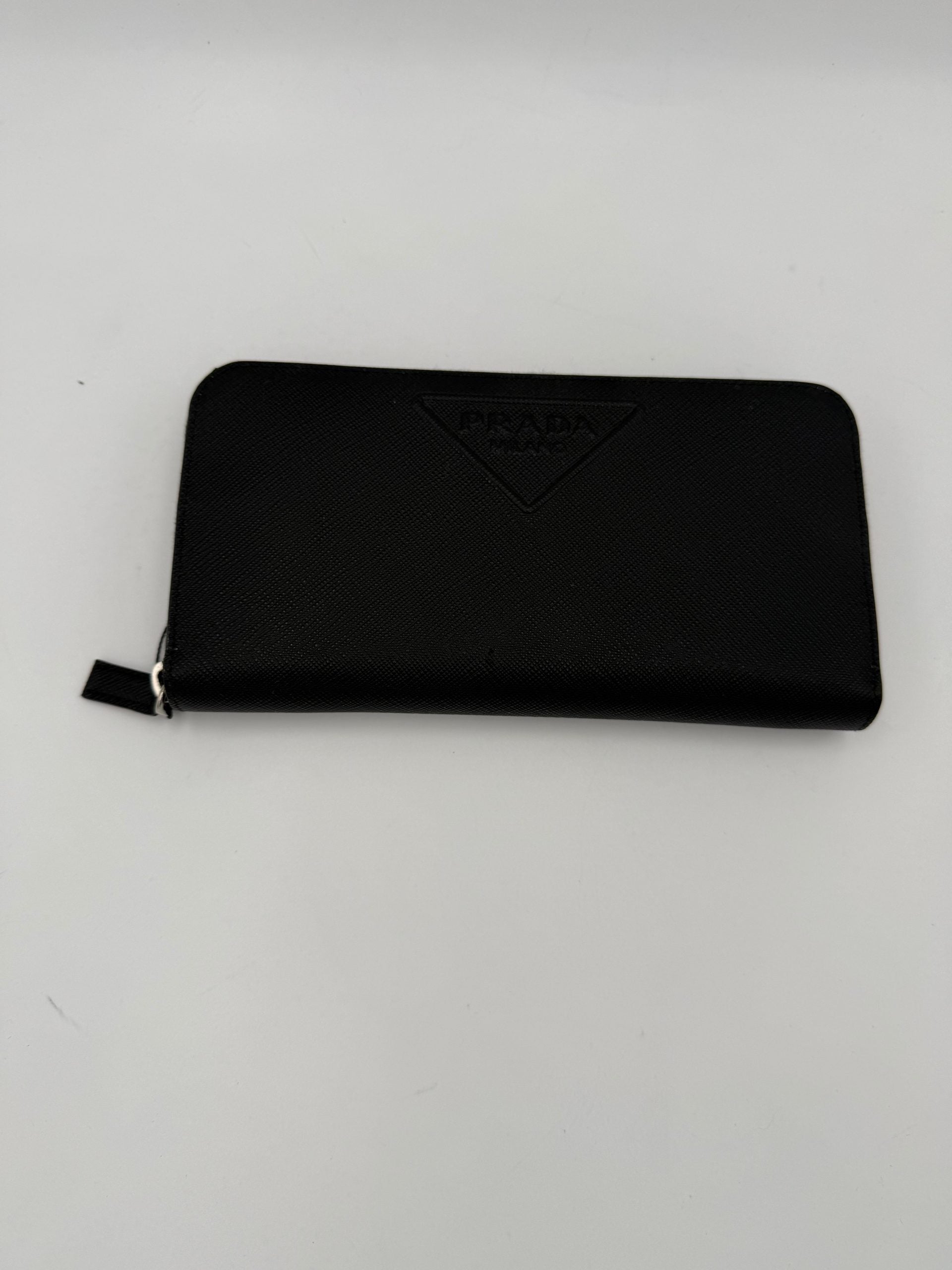 Indulge in the exquisite Prada PRADA Zip in Saffiano Leather Wallet, a symbol of refined luxury and impeccable craftsmanship, perfect for the discerning individual.