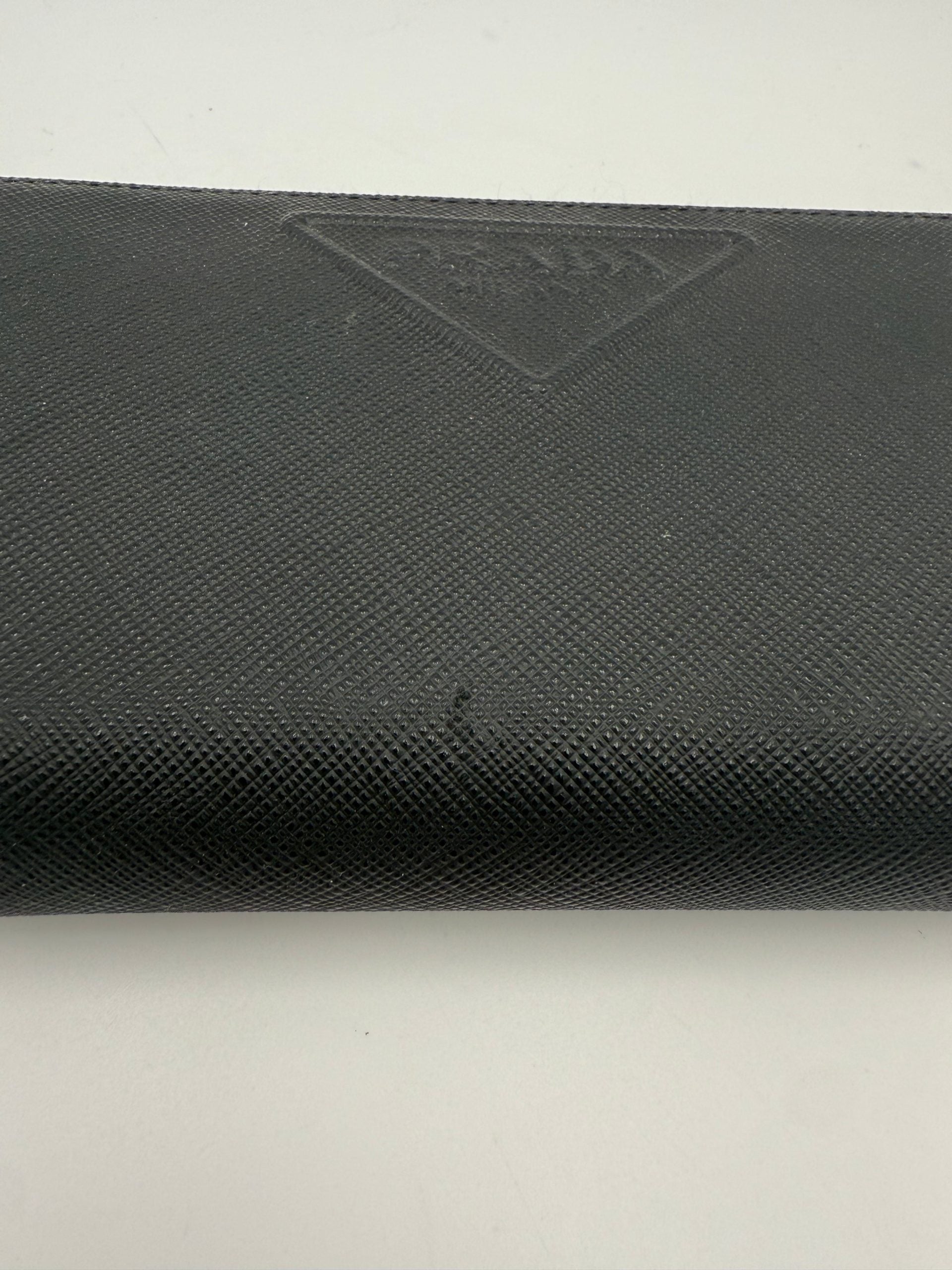 Indulge in the elegance of the Prada PRADA Zip in Saffiano Leather Wallet, a symbol of luxury and sophistication, crafted for discerning tastes.