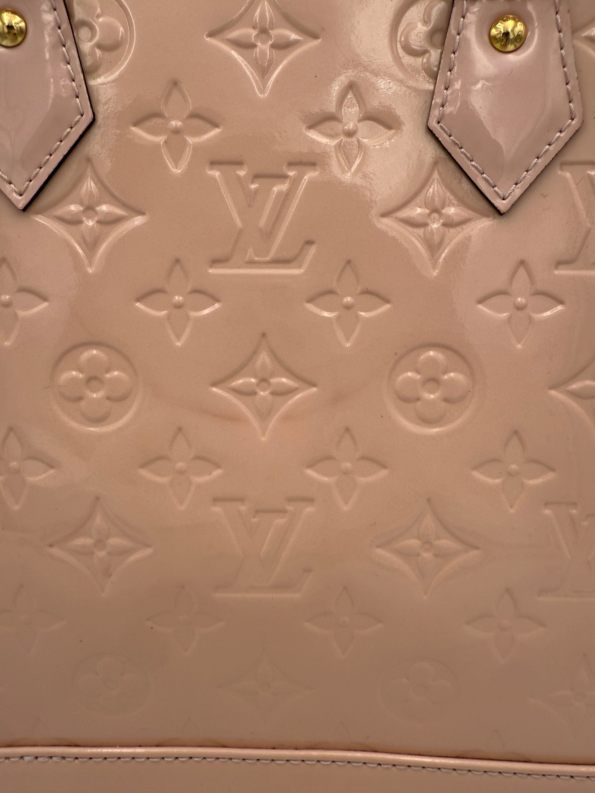 Indulge in the exquisite Louis Vuitton Alma MM Pink Patent Monogram Handbag, a timeless luxury piece that embodies iconic style and unparalleled craftsmanship for discerning tastes.