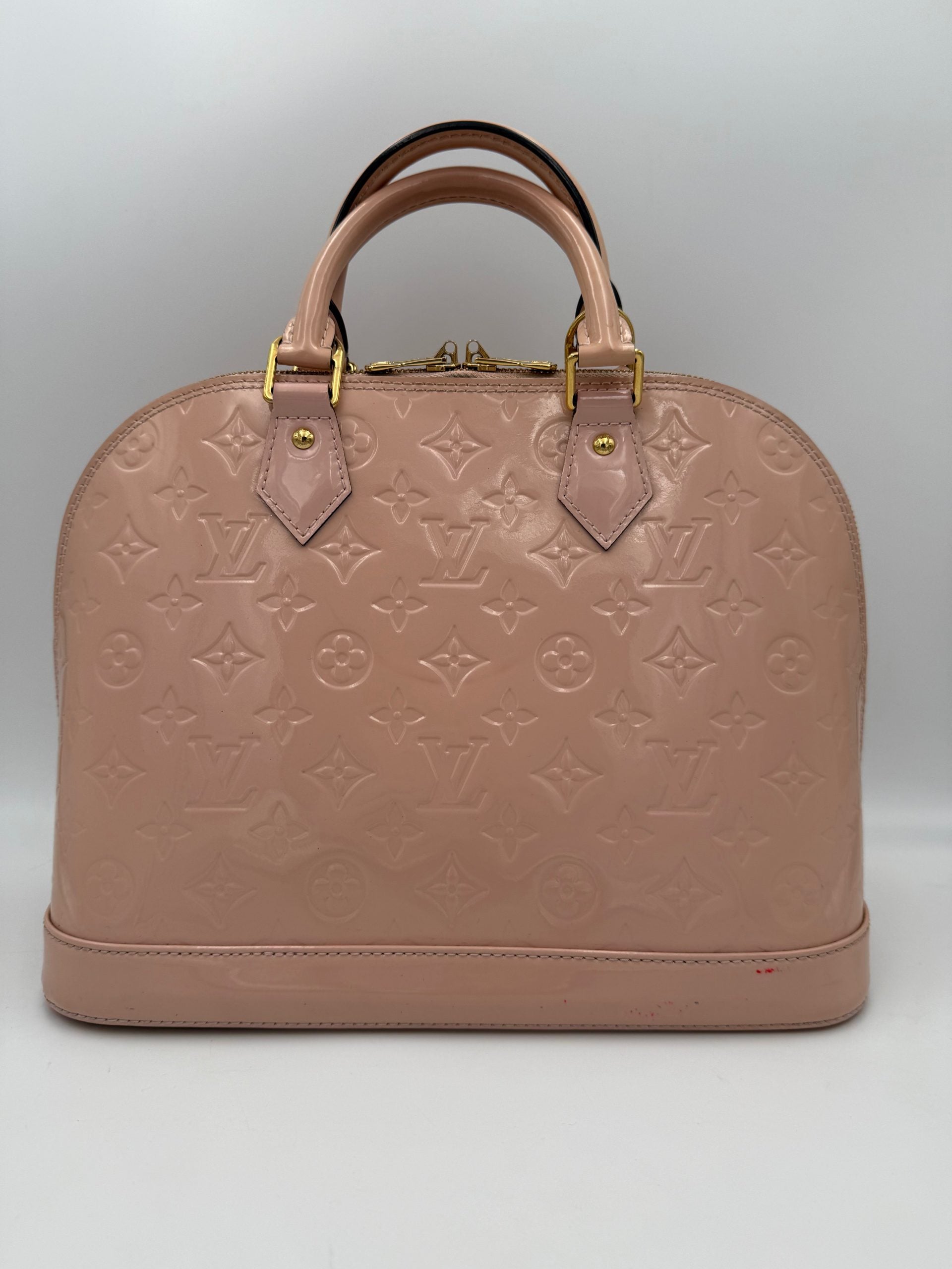 Elevate your style with the Louis Vuitton Alma MM Pink Patent Monogram Handbag, a timeless symbol of luxury and exquisite craftsmanship for discerning tastes.