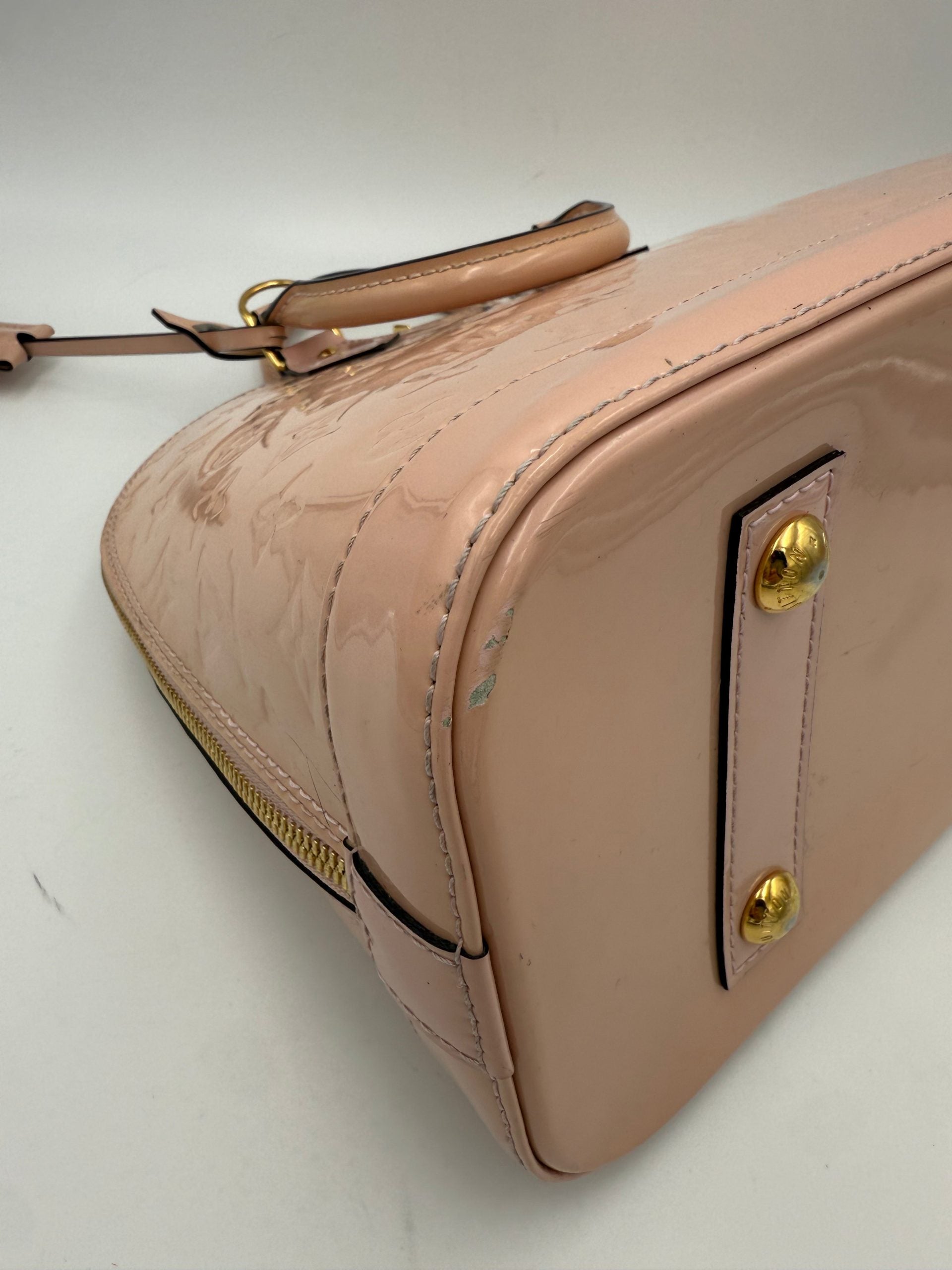 Indulge in the Louis Vuitton Alma MM Pink Patent Monogram Handbag, a timeless masterpiece that embodies exquisite craftsmanship and iconic luxury for discerning tastes.