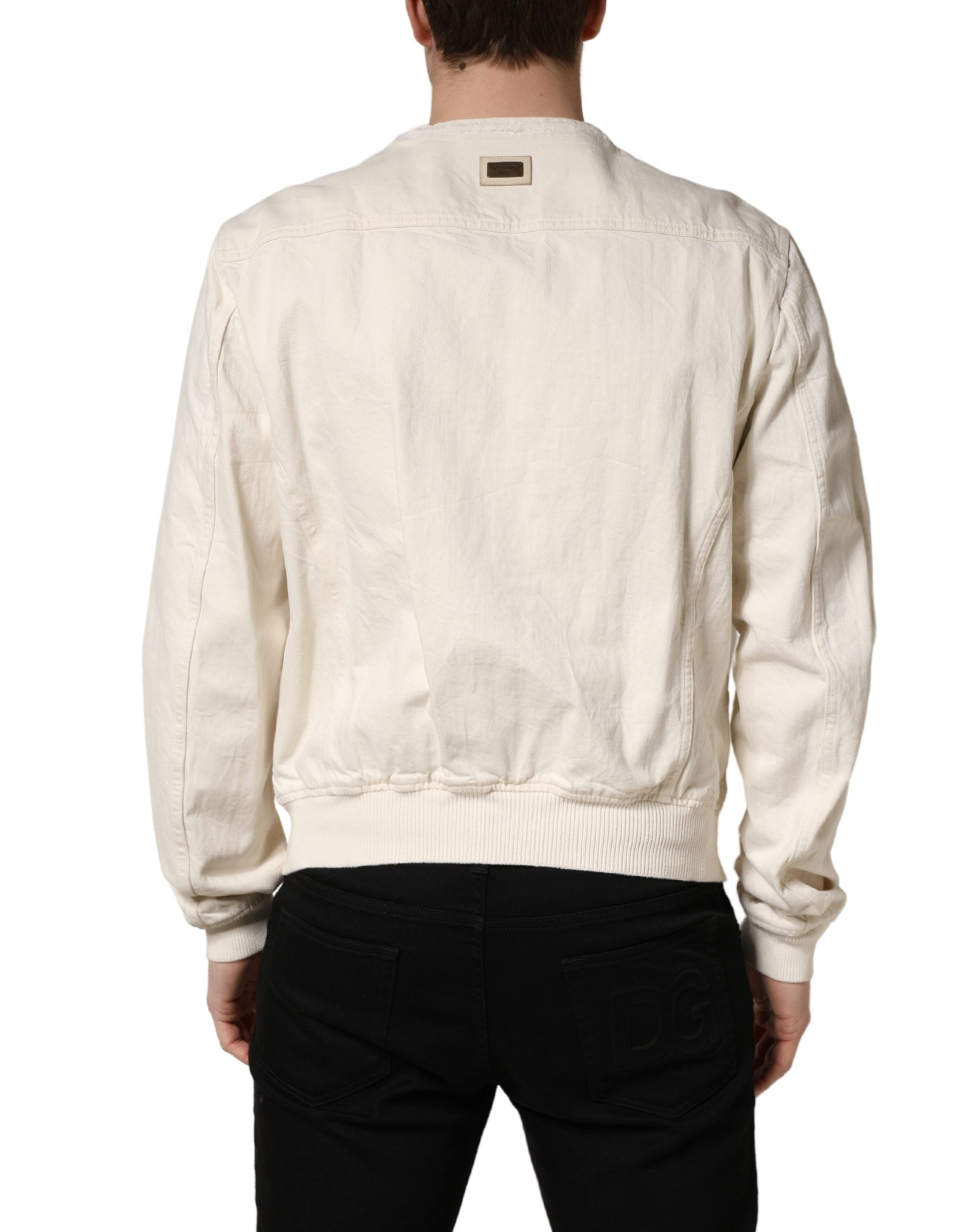 Indulge in the elegance of the Dolce & Gabbana Off White Cotton Full Zip Denim Blouson Jacket, where luxurious craftsmanship meets timeless style for the discerning individual.