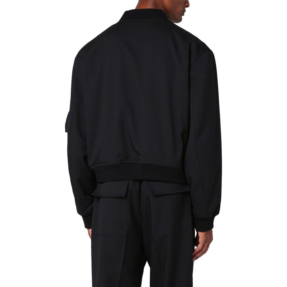 Elevate your style with the Jil Sander Black Polyester Bomber, a masterpiece of Italian craftsmanship that seamlessly blends elegance and functionality for the discerning individual.