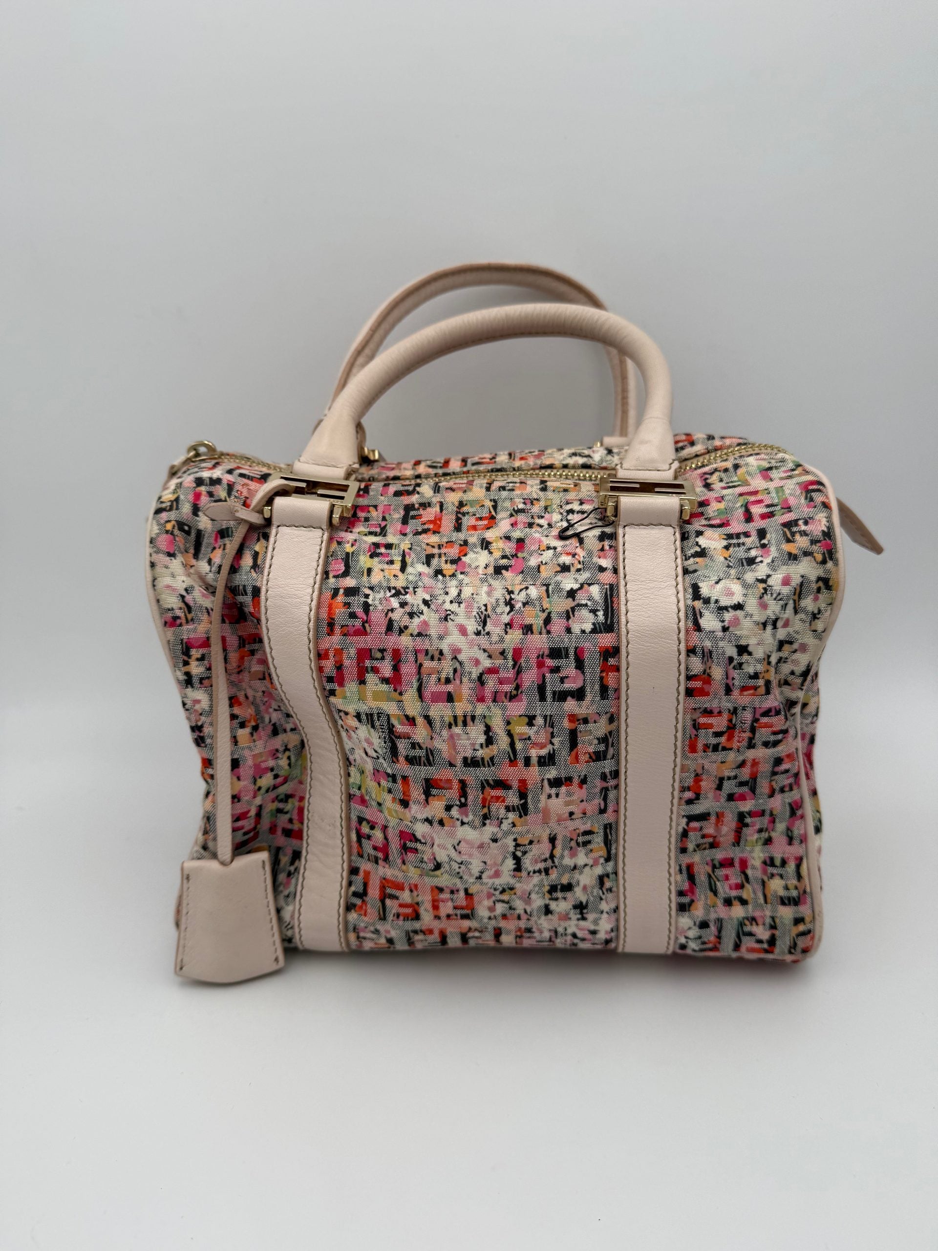 Discover the Fendi FENDI FF Canvas Fiori Handbag, a masterpiece of Italian craftsmanship adorned with floral motifs, embodying elegance and luxury for every occasion.