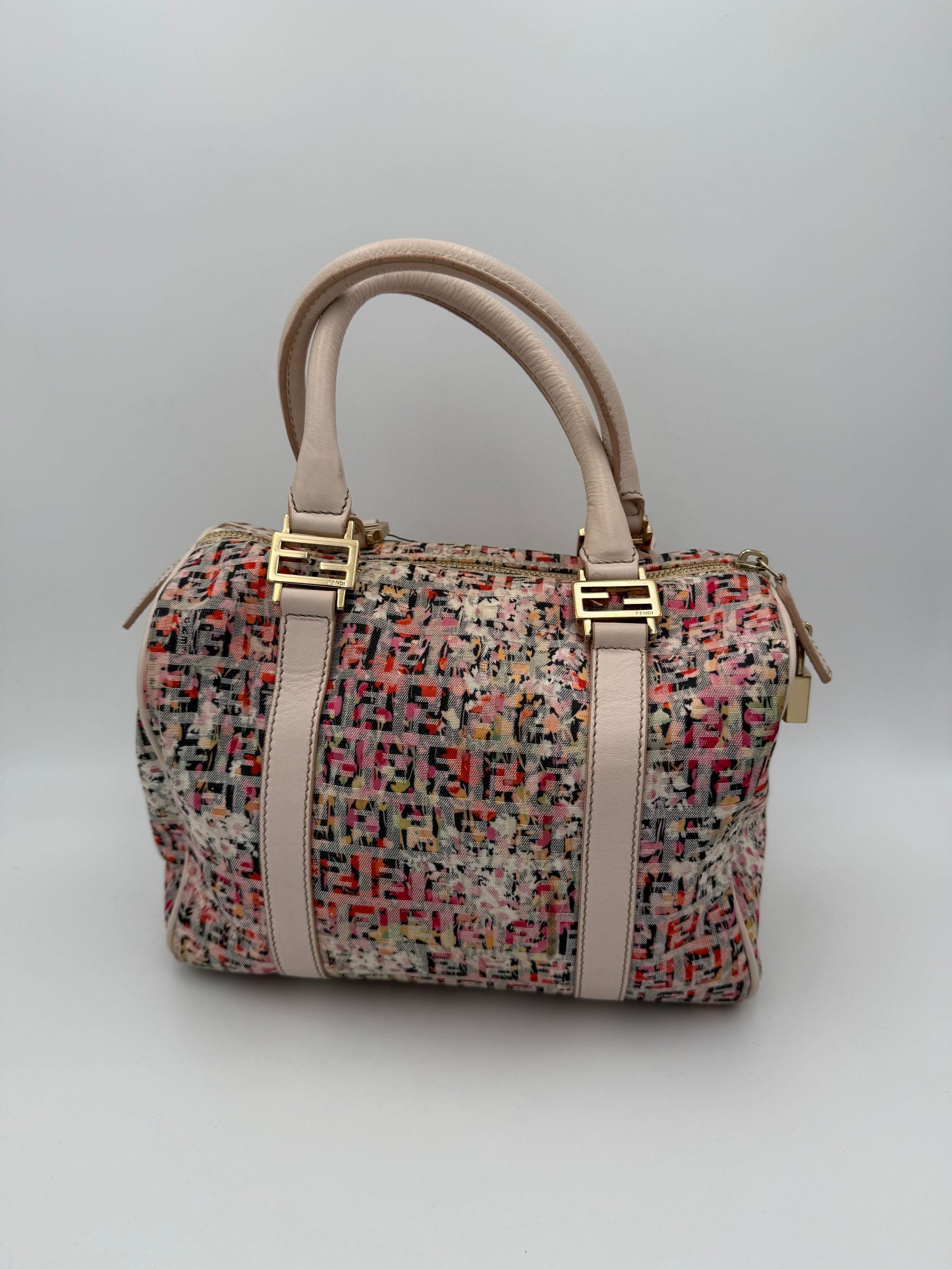 Indulge in the Fendi FENDI FF Canvas Fiori Handbag, a masterpiece of Italian craftsmanship adorned with floral motifs, perfect for elevating your summer elegance.