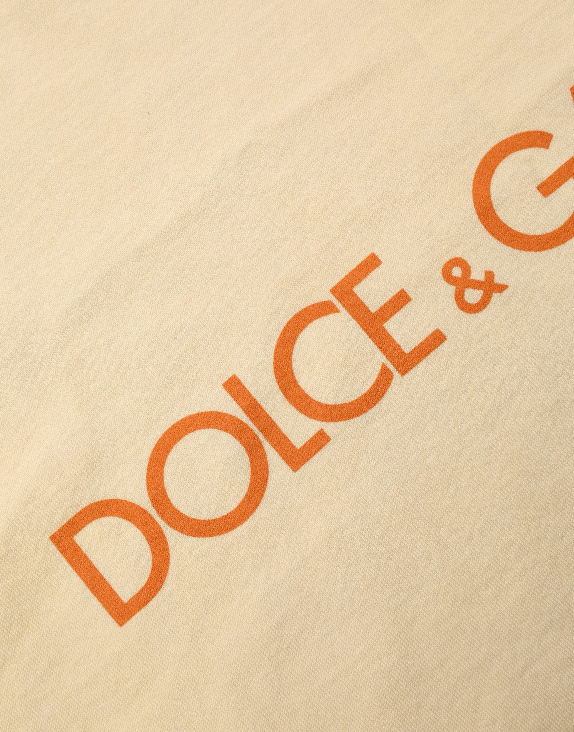 Discover the allure of Dolce & Gabbana's Yellow Logo Print Cotton Crew Neck T-shirt, a testament to Italian craftsmanship that elevates your style with effortless elegance.