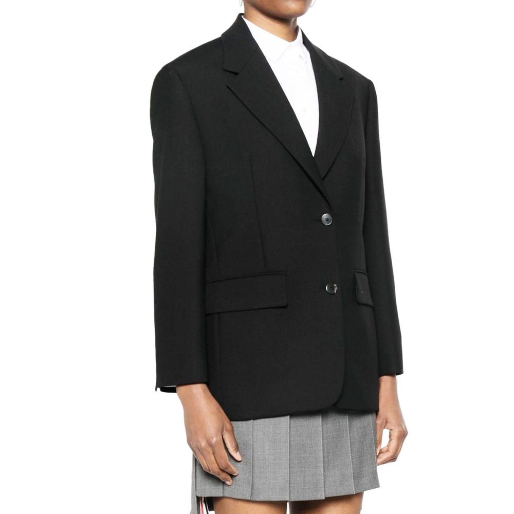 Elevate your wardrobe with the Prada Black Virgin Wool Blazer, a masterpiece of Italian craftsmanship, embodying timeless elegance and sophisticated allure.