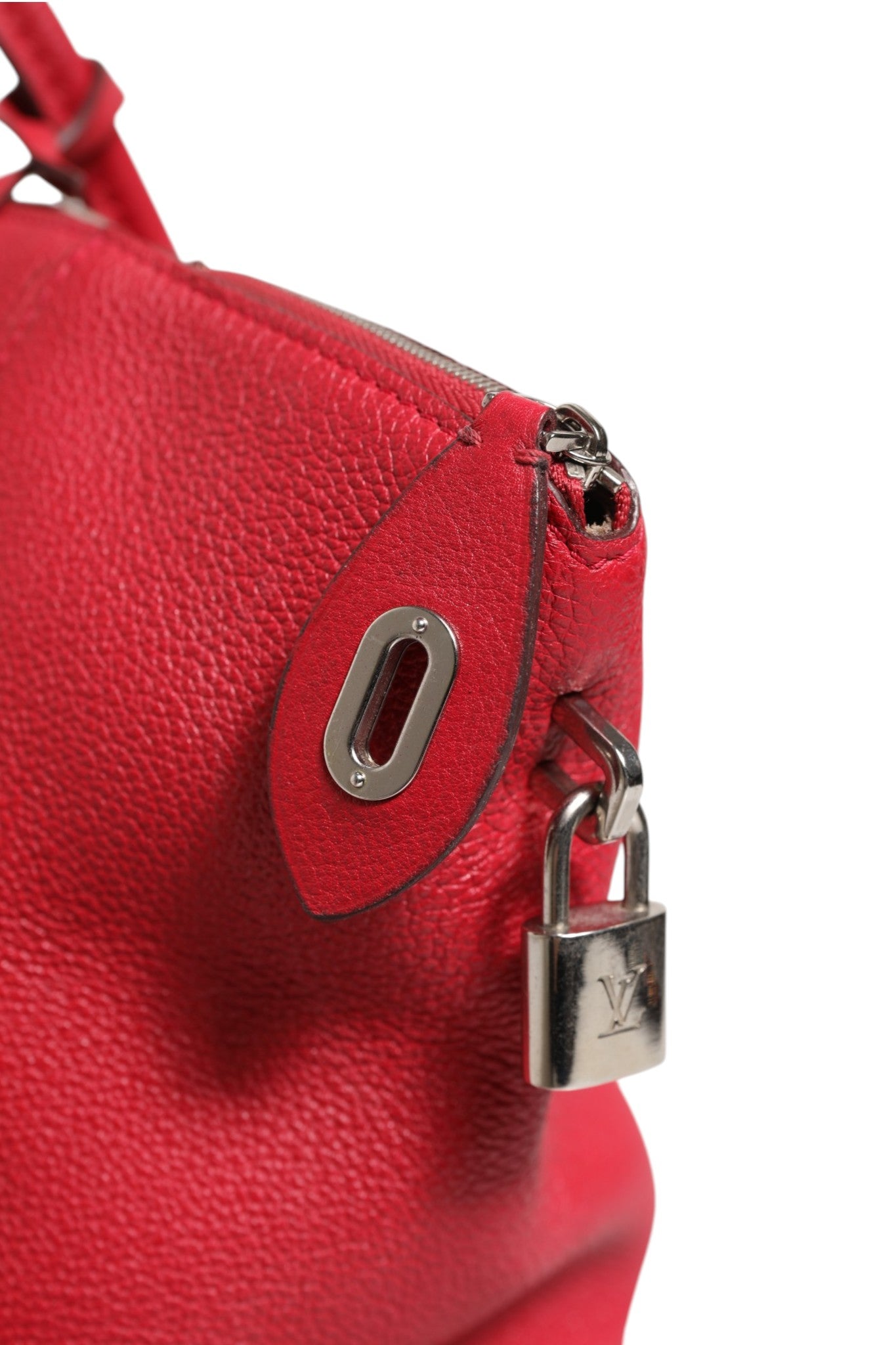 Indulge in the exquisite Louis Vuitton Griotte Taurillon Leather Soft Lockit MM Crossbody Bag, a masterpiece of luxurious craftsmanship that elevates your style with its bold red hue and timeless elegance.