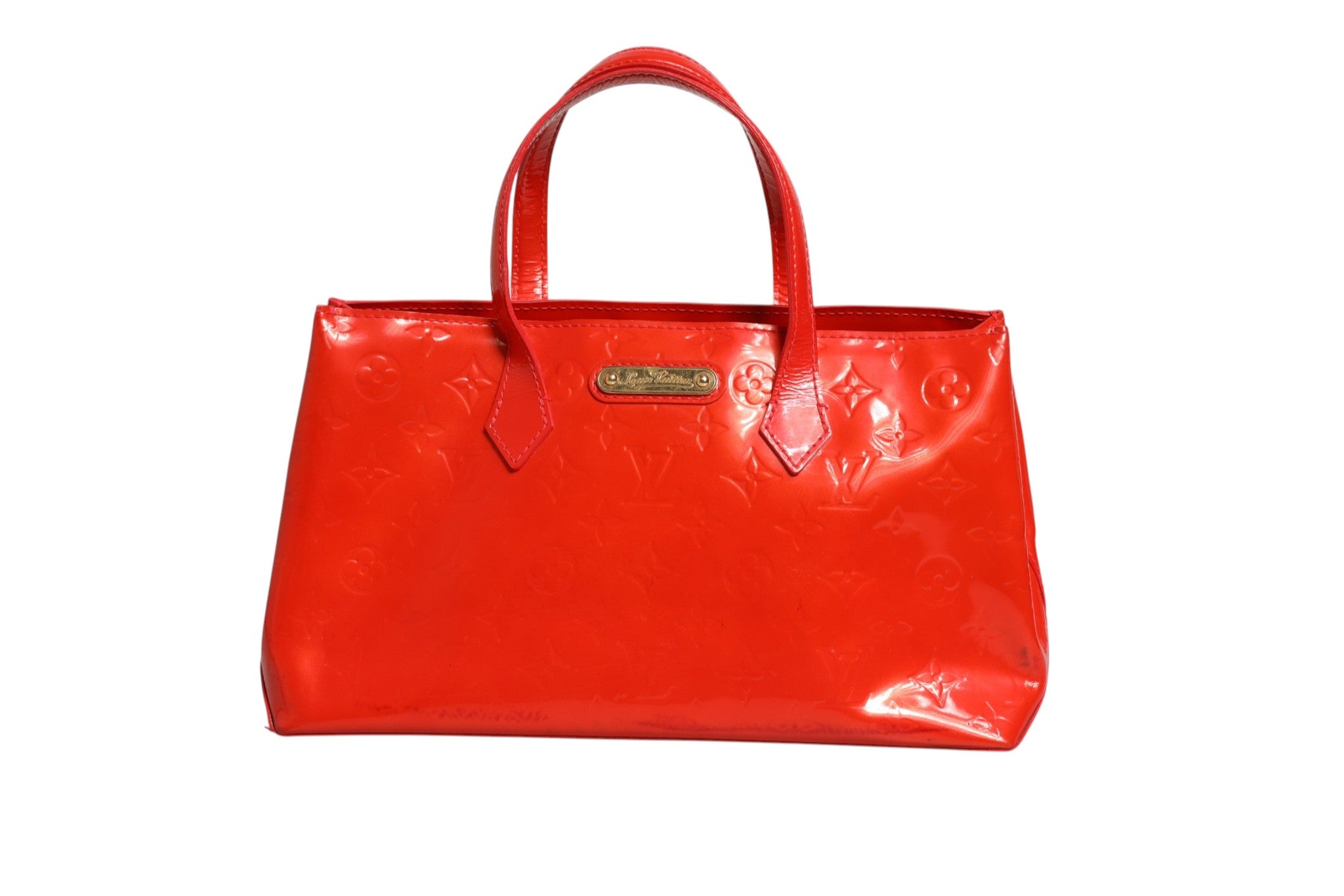Discover the Louis Vuitton Red Monogram Vernis Wilshire PM, a masterpiece of exquisite craftsmanship that embodies timeless elegance and sophistication for discerning tastes.