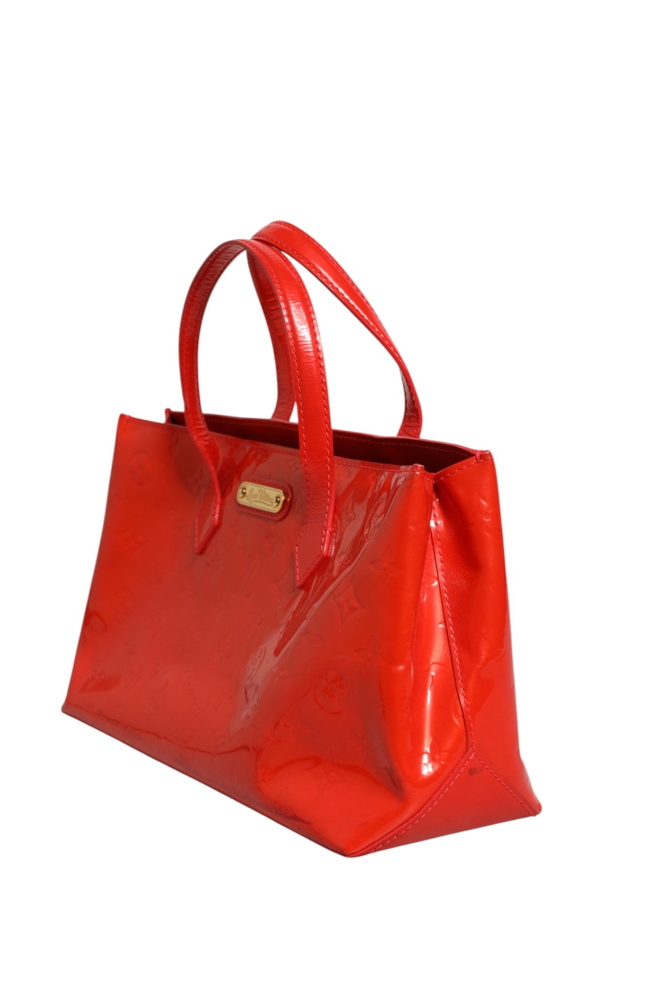 Experience the allure of the Louis Vuitton Red Monogram Vernis Wilshire PM, a masterpiece of exquisite craftsmanship that embodies timeless elegance and sophistication.