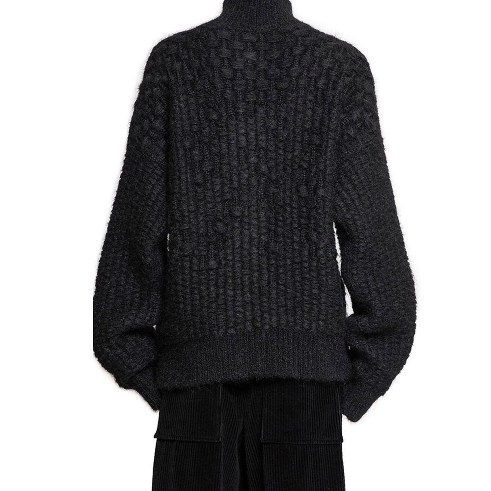 Indulge in the Jil Sander Black Alpaca Leather Cardigan, a luxurious blend of alpaca and mohair, embodying timeless elegance and Italian craftsmanship for the discerning wardrobe.