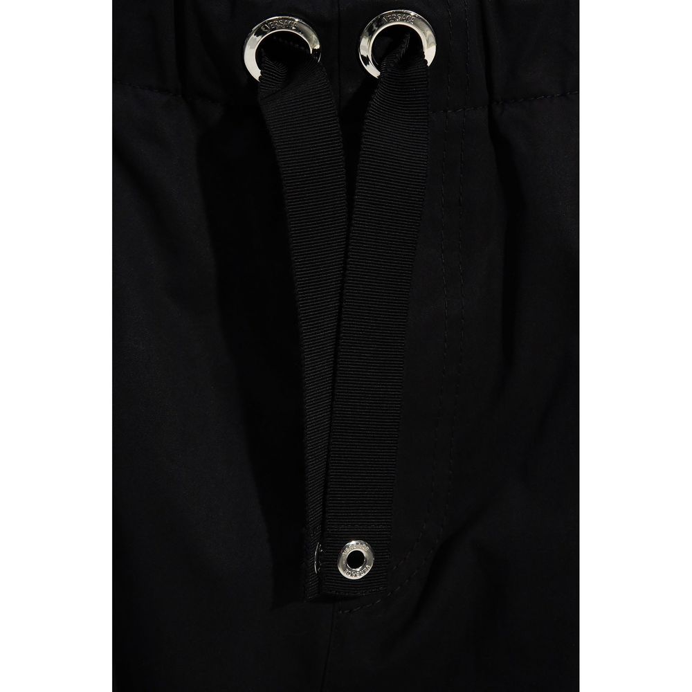 Elevate your wardrobe with Versace's Black Cotton Casual Pants, a blend of exquisite craftsmanship and luxurious comfort, perfect for the discerning modern connoisseur.