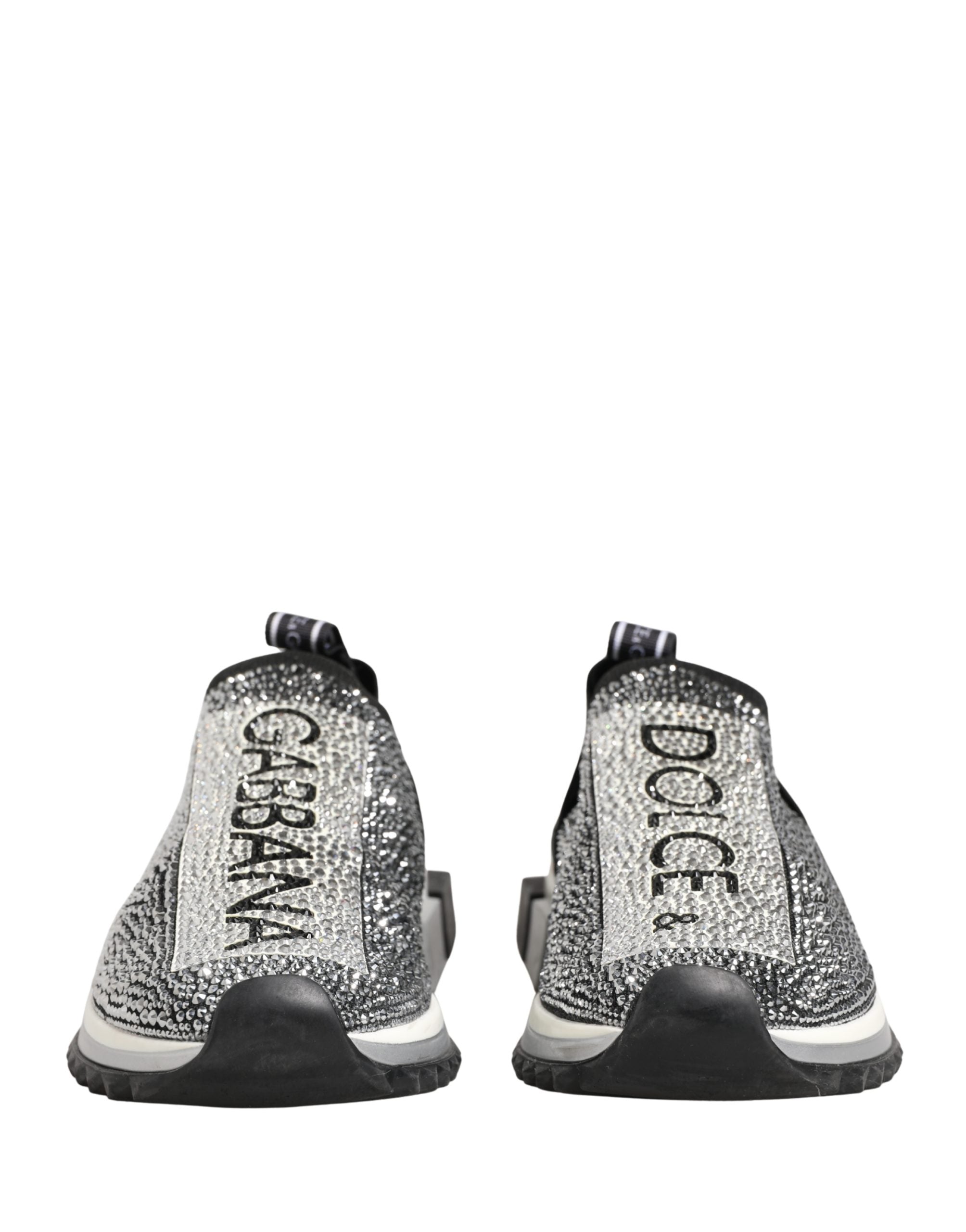 Experience the allure of Dolce & Gabbana's Silver Crystal Logo Slip On Sorrento Sneakers, where Italian craftsmanship meets luxurious comfort for the discerning individual.