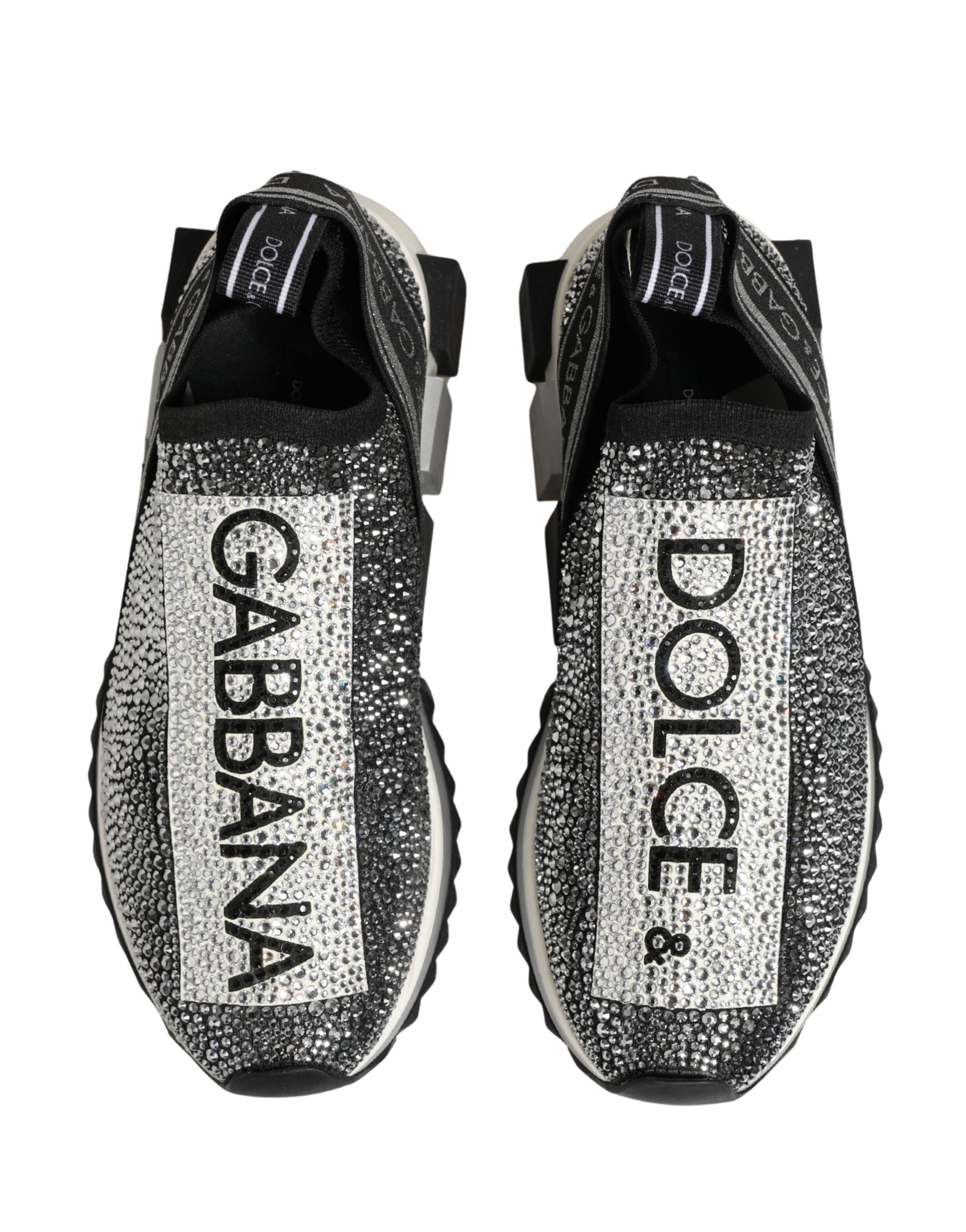 Elevate your style with Dolce & Gabbana's Silver Crystal Logo Slip On Sorrento Sneakers, where Italian craftsmanship meets luxurious materials for an exquisite statement.