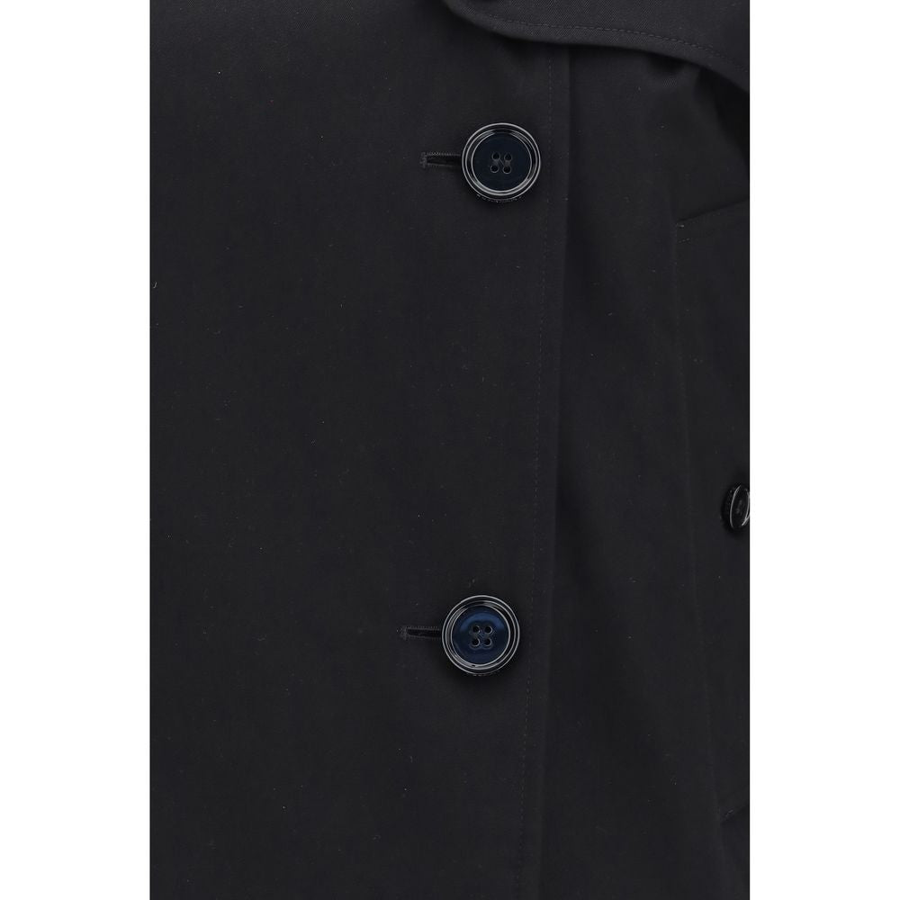 Experience the allure of the Burberry Black Cotton Trench Coat, crafted from rain-resistant gabardine, merging timeless elegance with modern sophistication for the discerning individual.