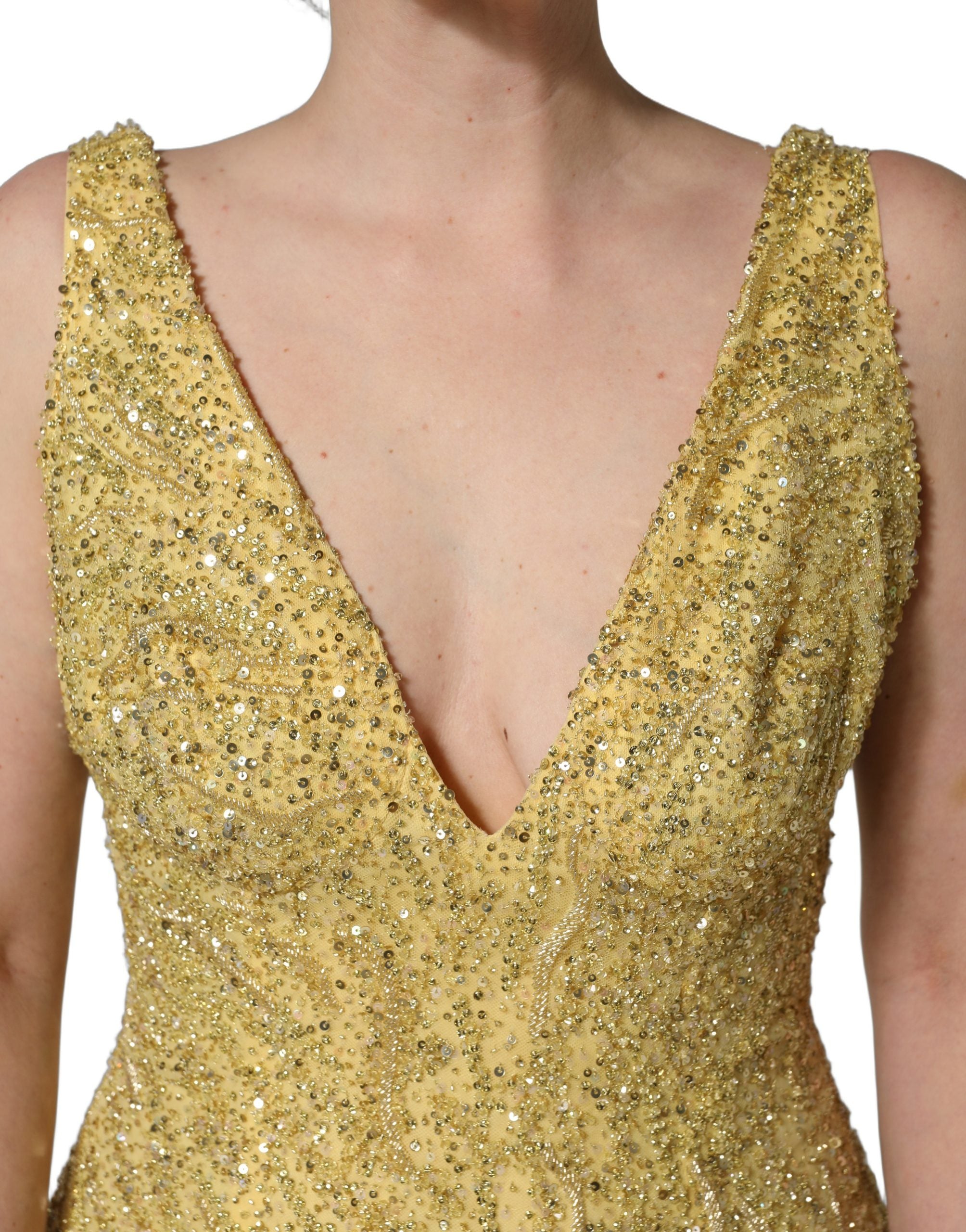 Indulge in the exquisite Dolce & Gabbana Gold V-neckline Mermaid Sequinned Gown, a masterpiece of silk and glass that embodies luxury and elegance for unforgettable moments.