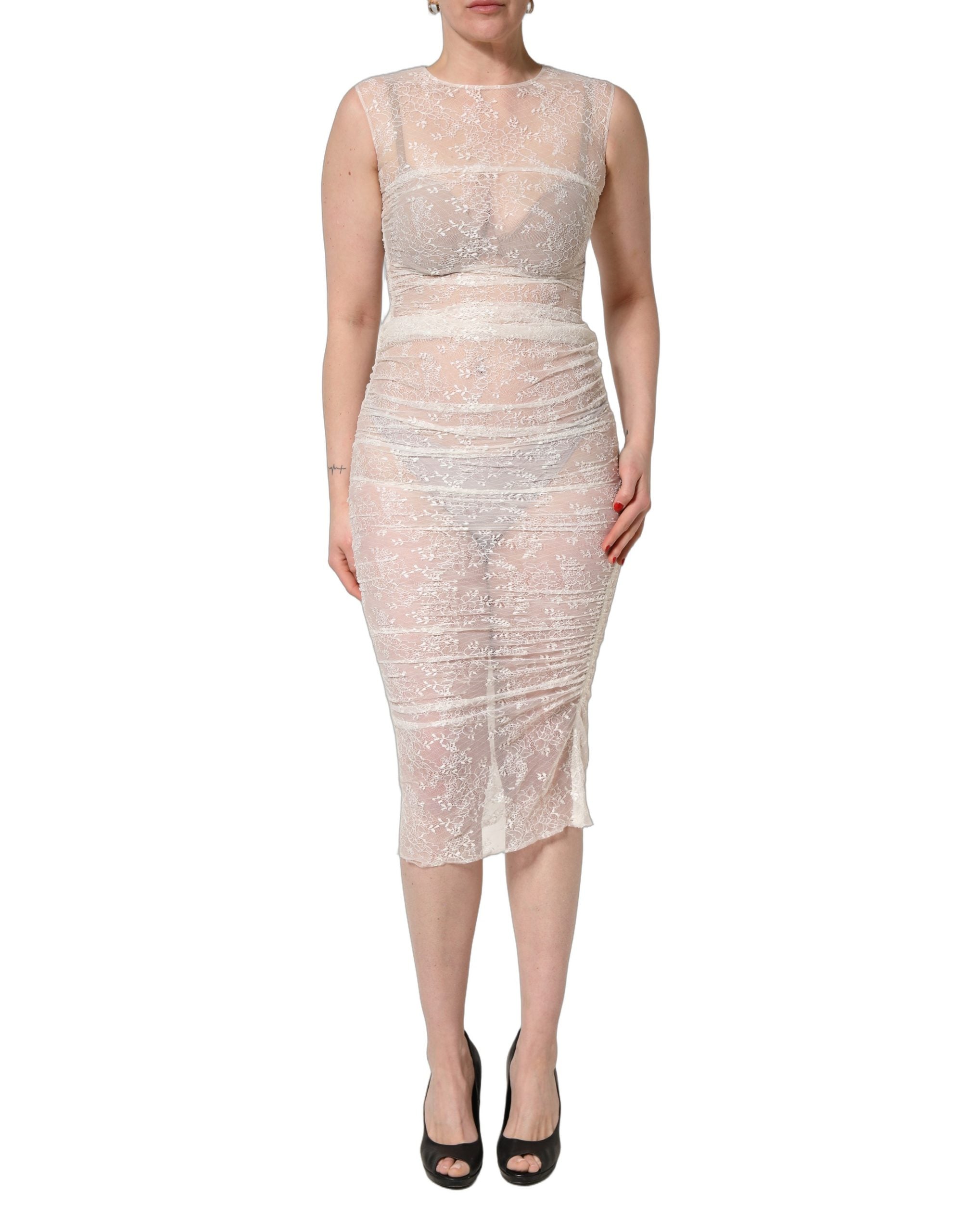 Experience the allure of the Dolce & Gabbana White Floral Lace Sheer Sleeveless Midi Dress, a masterpiece of Italian craftsmanship that embodies timeless elegance and sophistication.
