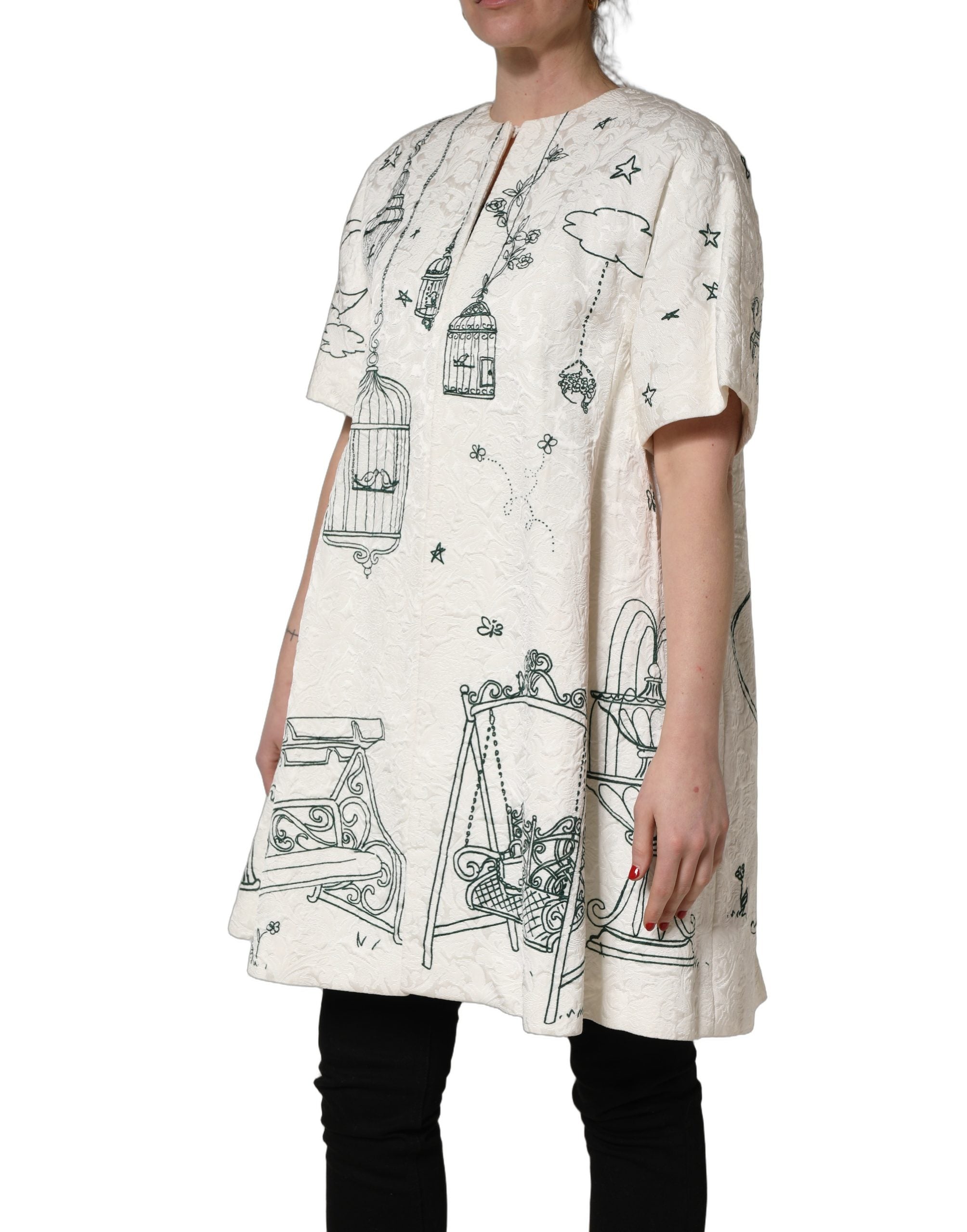 Elevate your wardrobe with the Dolce & Gabbana White Jacquard Garden Print Coat, a luxurious blend of silk and cotton, embodying Italian craftsmanship and timeless elegance.