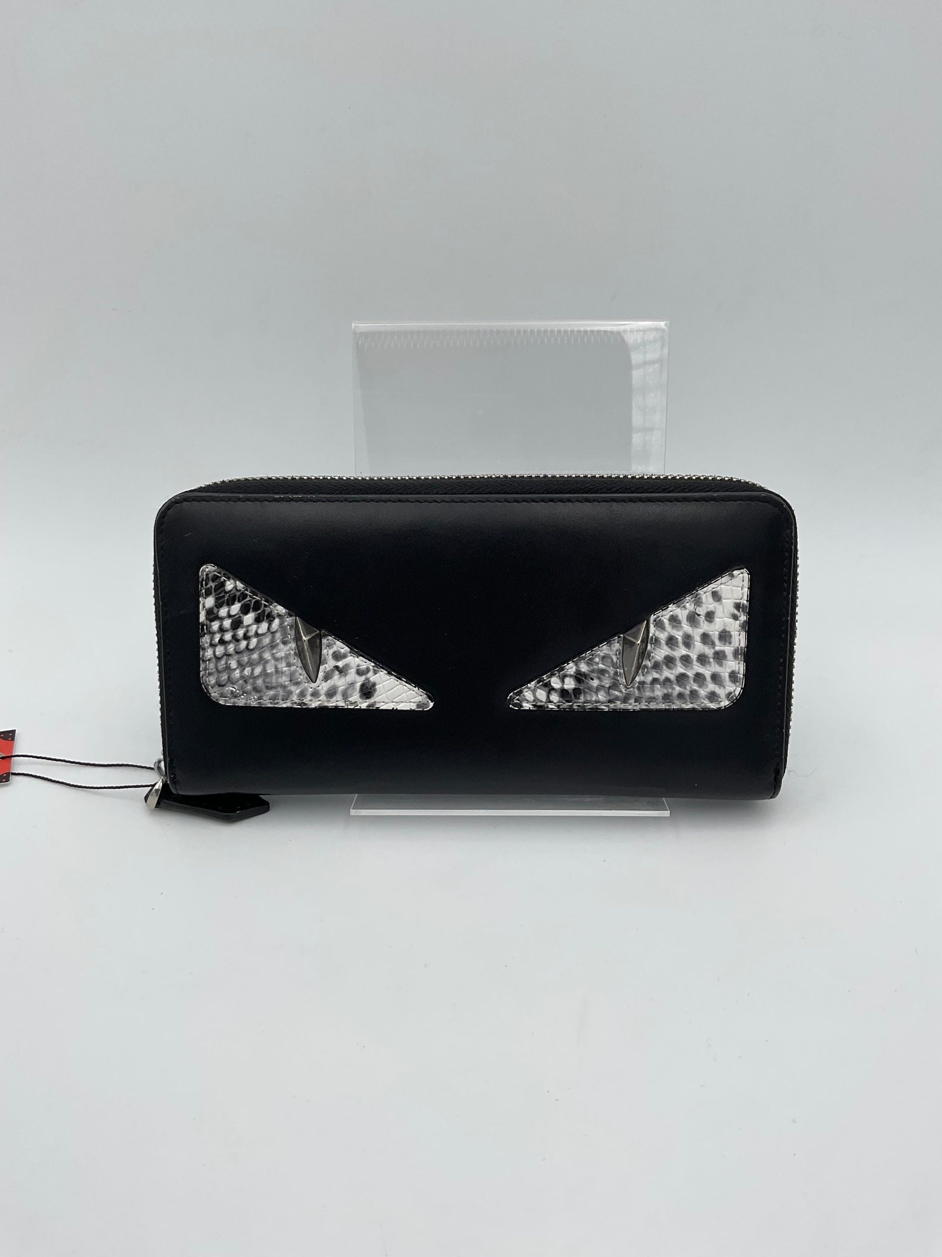 Discover the Fendi FENDI BUGS Wallet, a luxurious blend of calfskin and python, embodying exquisite craftsmanship and timeless elegance for the discerning collector.