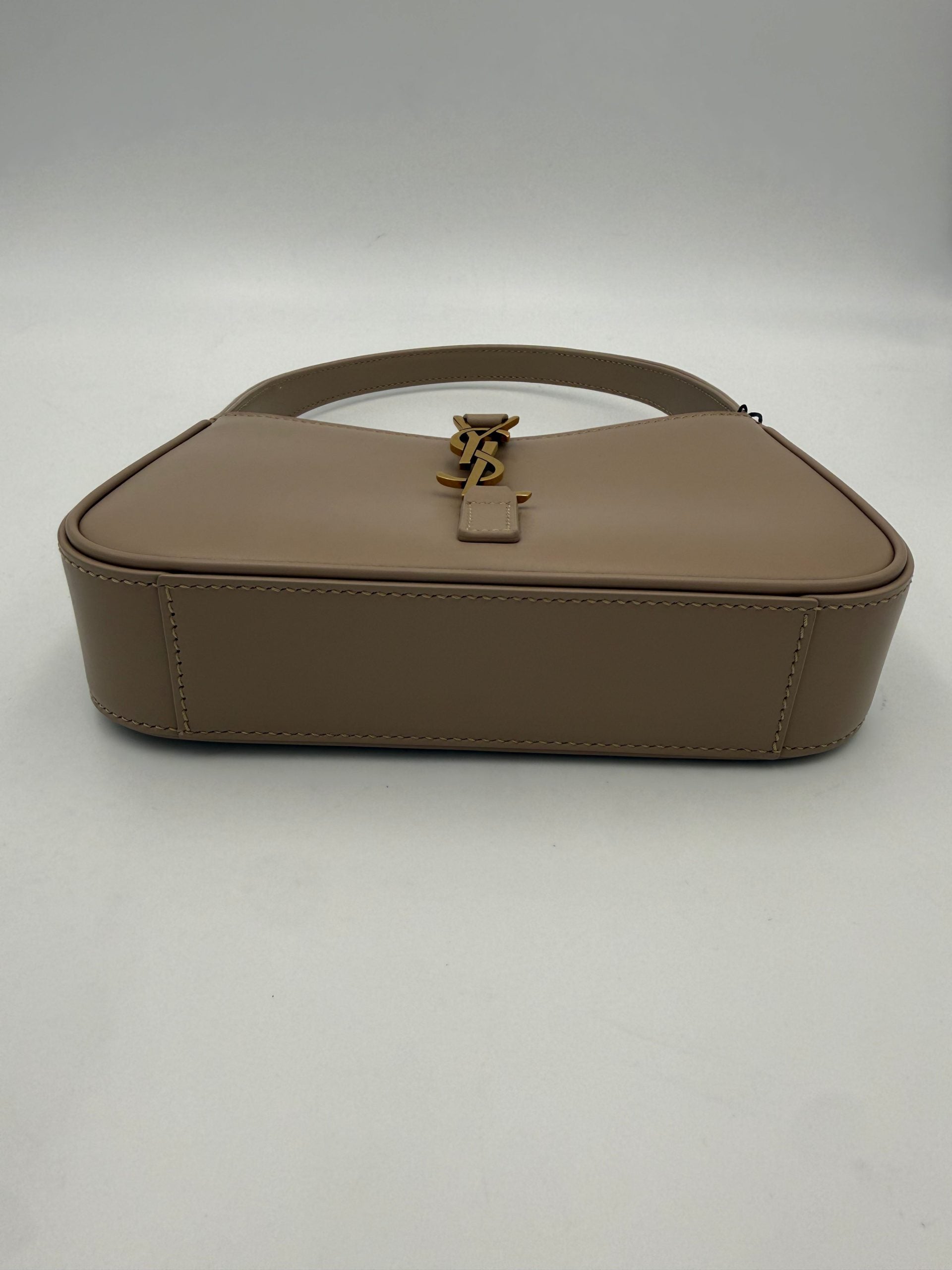Discover the Saint Laurent LA 5 A 7 Mini Handbag, a masterpiece in plain leather with golden hardware, embodying timeless elegance and artisanal luxury for every occasion.