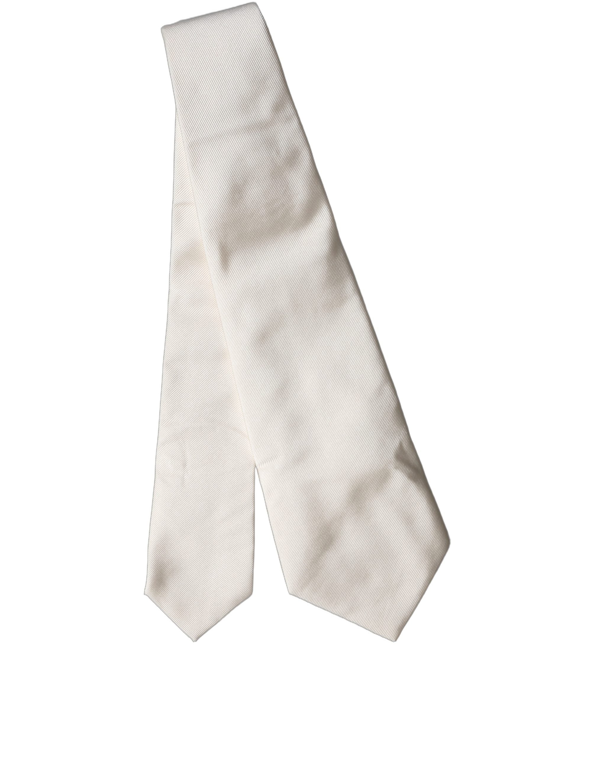 Experience the allure of Dolce & Gabbana's Off White Solid Silk Adjustable Necktie, a symbol of Italian craftsmanship that elevates your style with timeless elegance.
