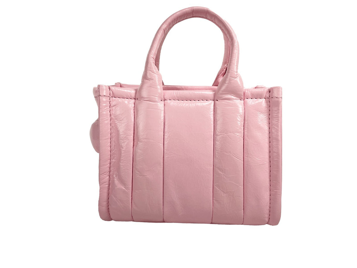 Elevate your style with the Marc Jacobs The Shiny Crinkle Micro Tote, a luxurious patent leather masterpiece that embodies contemporary sophistication and versatility.