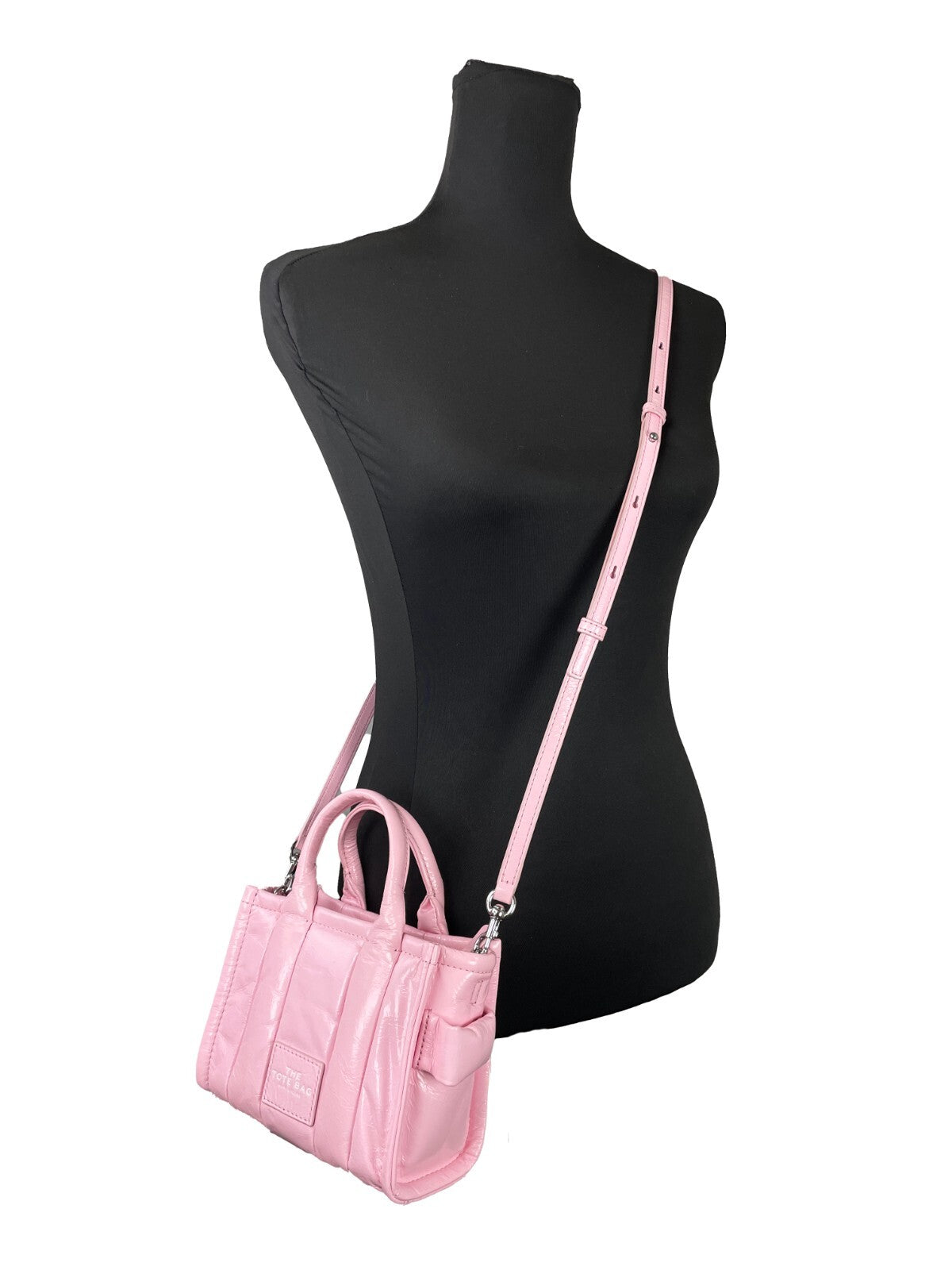 Indulge in the allure of Marc Jacobs The Shiny Crinkle Micro Tote, a luxurious bubblegum leather masterpiece that redefines elegance and versatility for the discerning individual.