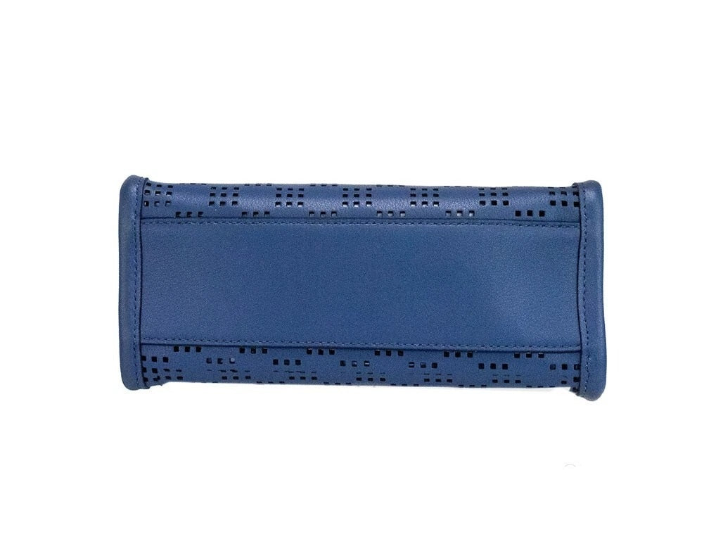Elevate your style with the Marc Jacobs Mini Grind Blue Sea Perforated Leather Crossbody Tote, a masterpiece of exceptional craftsmanship and luxurious design for the discerning individual.