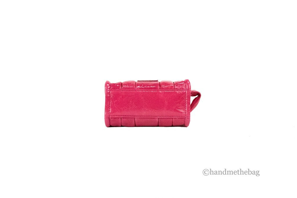 Experience the allure of Marc Jacobs The Shiny Crinkle Micro Tote, a magenta patent leather masterpiece that embodies elegance and sophistication for the discerning individual.