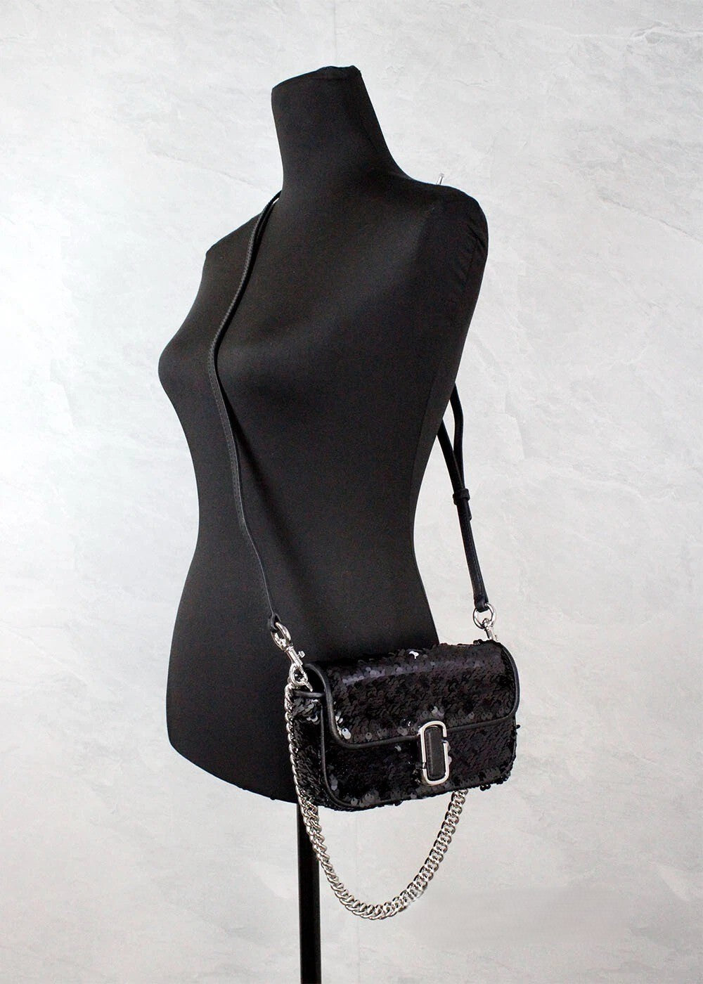 Elevate your style with the Marc Jacobs The Mini J Marc Shoulder Bag, a stunning black sequined crossbody that embodies exquisite craftsmanship and timeless elegance.