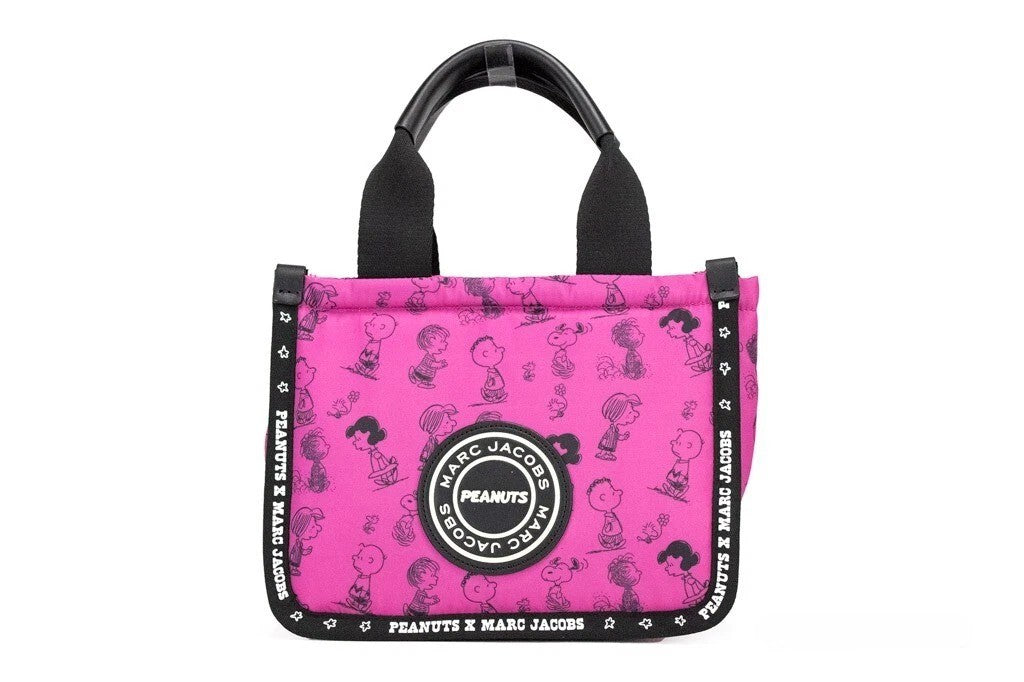 Elevate your style with the Marc Jacobs X Peanuts Mini Fuchsia Fedora Tote, a limited edition masterpiece in durable nylon, blending whimsical charm with luxurious craftsmanship.