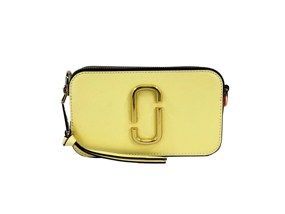 Indulge in the exquisite allure of Marc Jacobs The Snapshot Crossbody Bag, crafted from high-quality leather, embodying playful sophistication for the discerning individual.