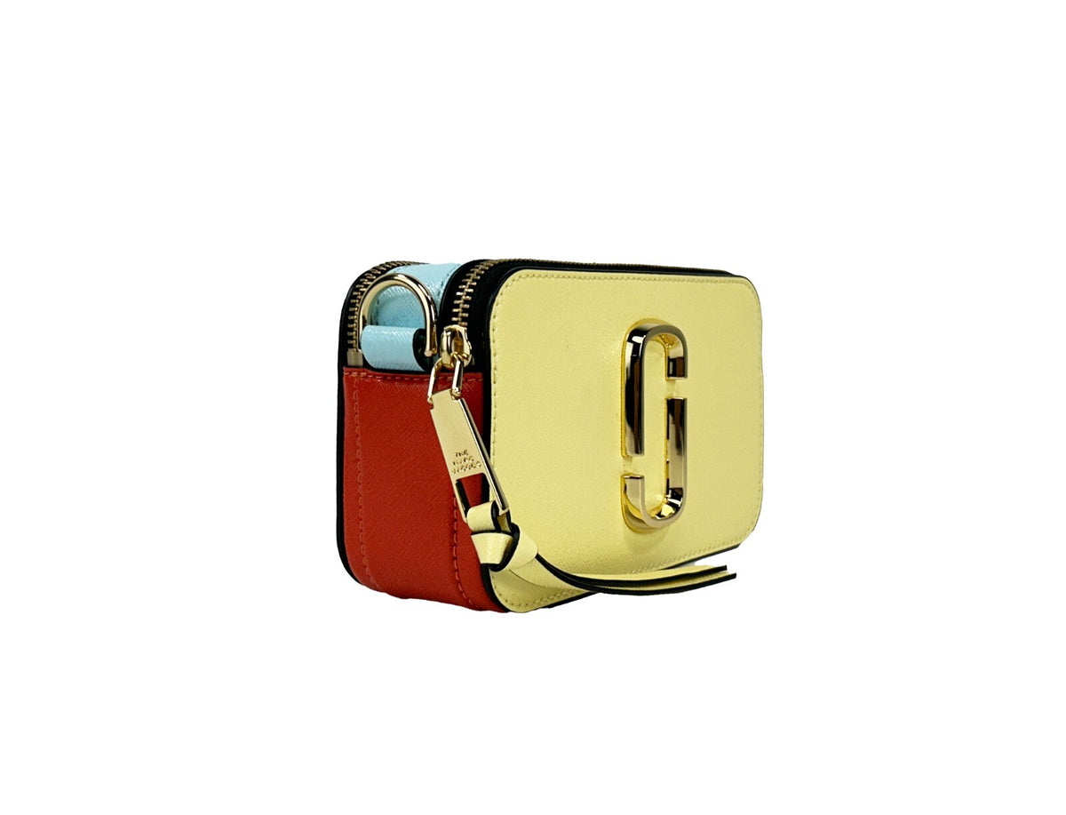 Indulge in the exquisite Marc Jacobs The Snapshot Crossbody Bag, crafted from high-quality leather, merging playful elegance with timeless sophistication for discerning individuals.