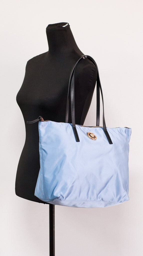 Discover the Versace Portuna Medusa Medium Tote Bag, a blend of durable nylon and luxurious calf leather, embodying sophistication and timeless elegance for the discerning individual.