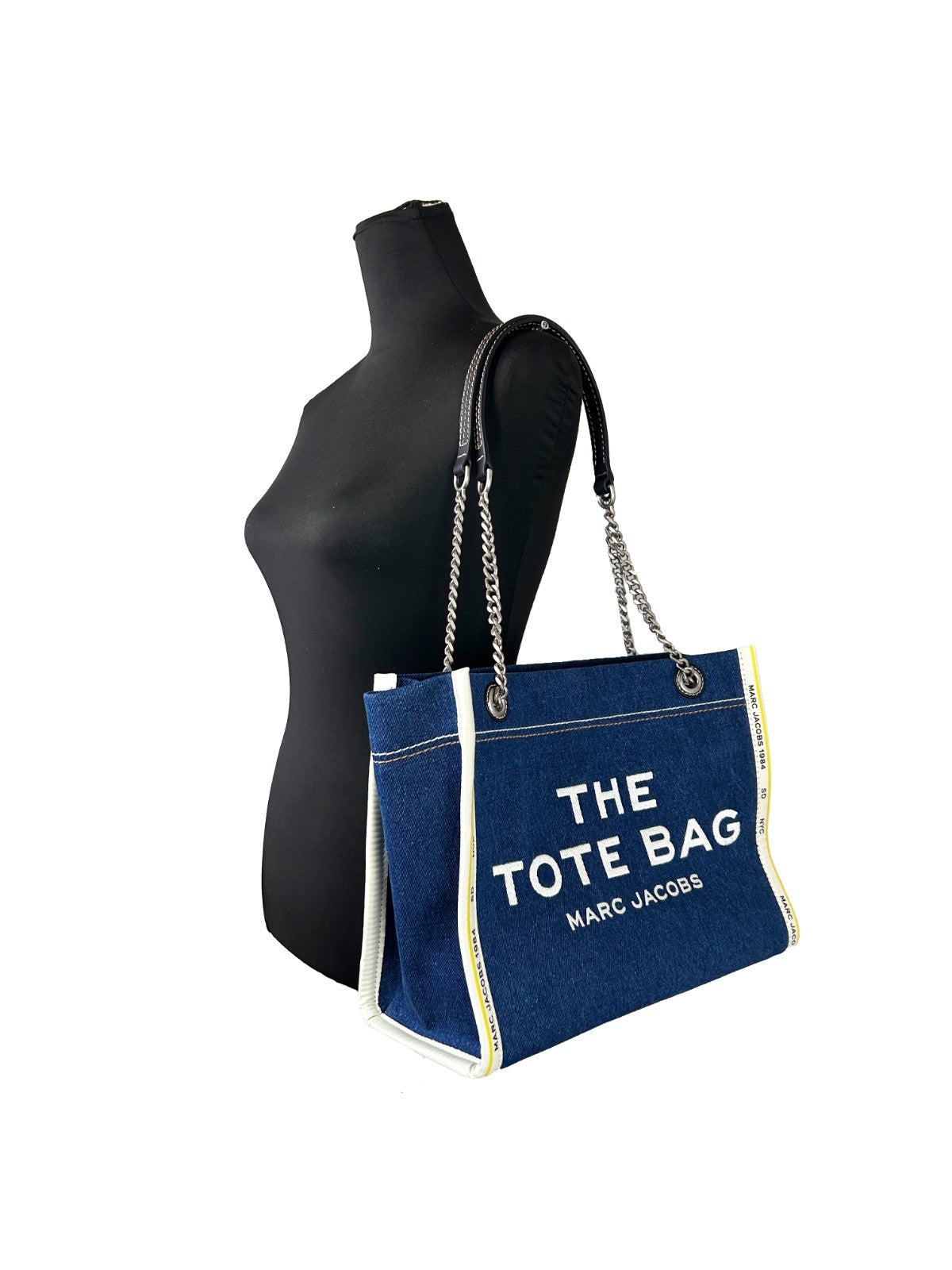Experience the allure of the Marc Jacobs Denim Chain Medium Tote Bag, where exquisite craftsmanship meets urban sophistication, perfect for elevating any ensemble.
