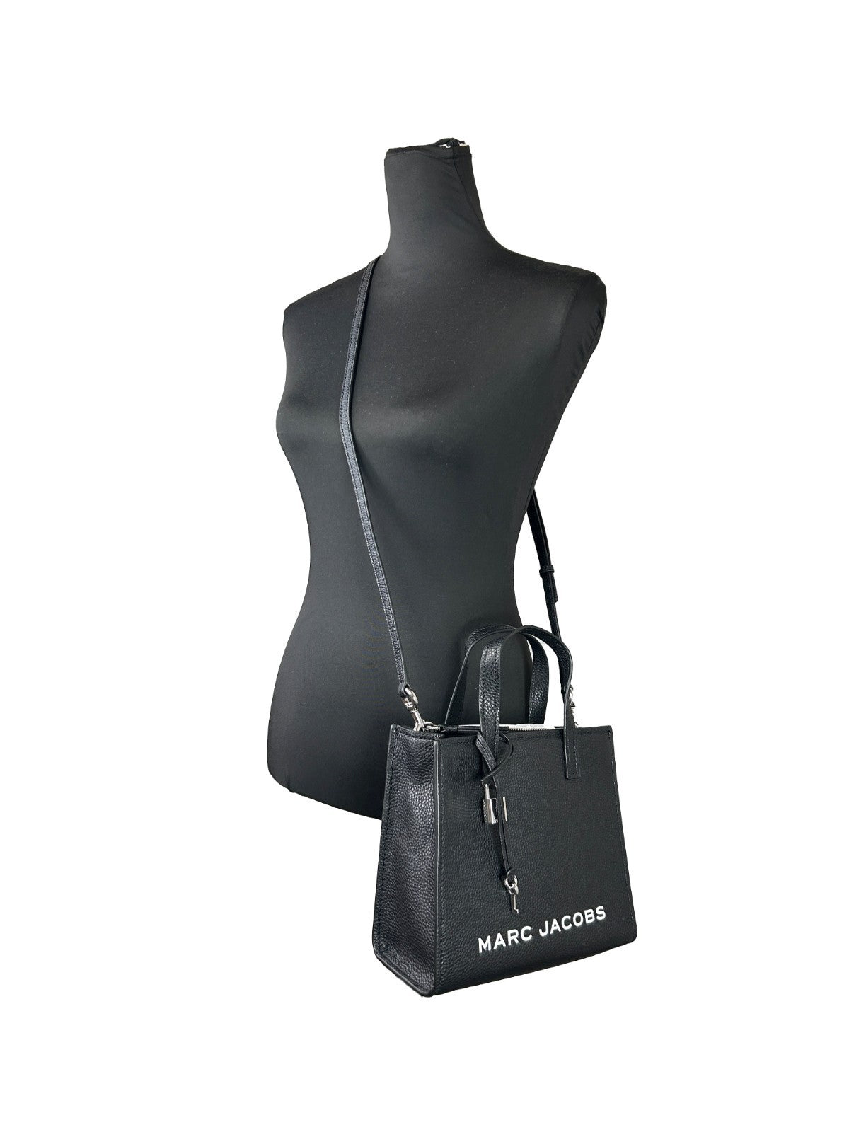 Indulge in the Marc Jacobs Mini Grind Black Leather Crossbody Bag, a masterpiece of artisanal luxury, blending exquisite pebbled leather with timeless elegance for discerning individuals.