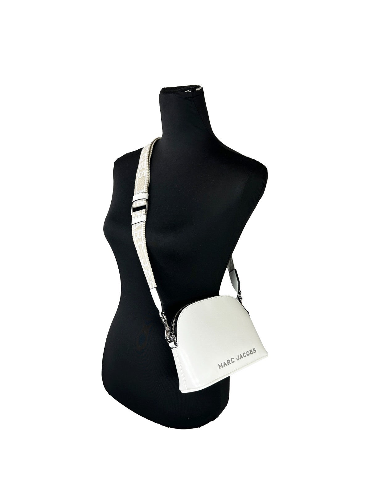 Elevate your elegance with the Marc Jacobs Small Leather Dome Crossbody Bag, a masterpiece of patent leather that embodies timeless luxury and sophisticated allure.