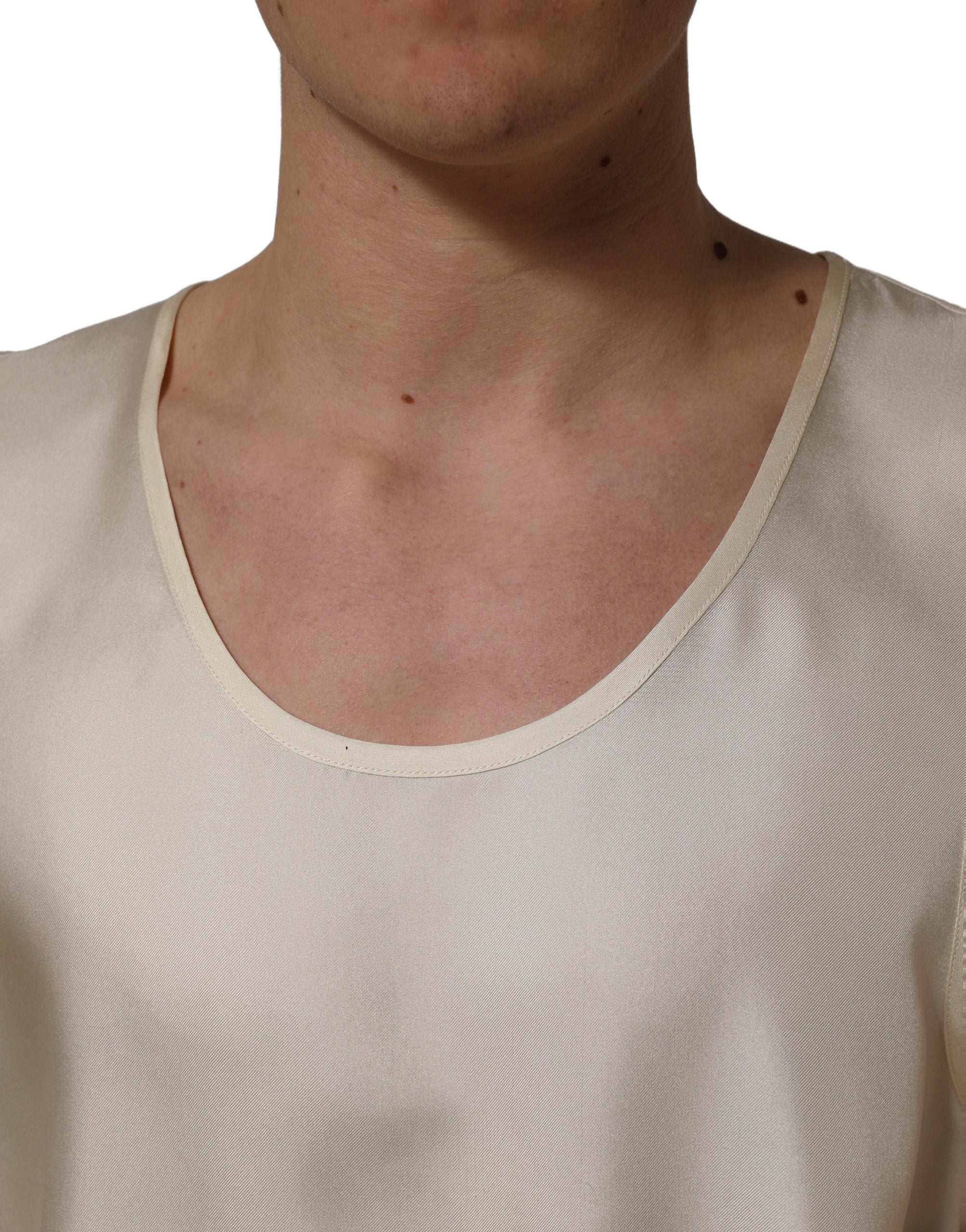 Elevate your wardrobe with Dolce & Gabbana's off-white silk sleeveless tank, a timeless piece embodying Italian craftsmanship and luxurious allure for every occasion.