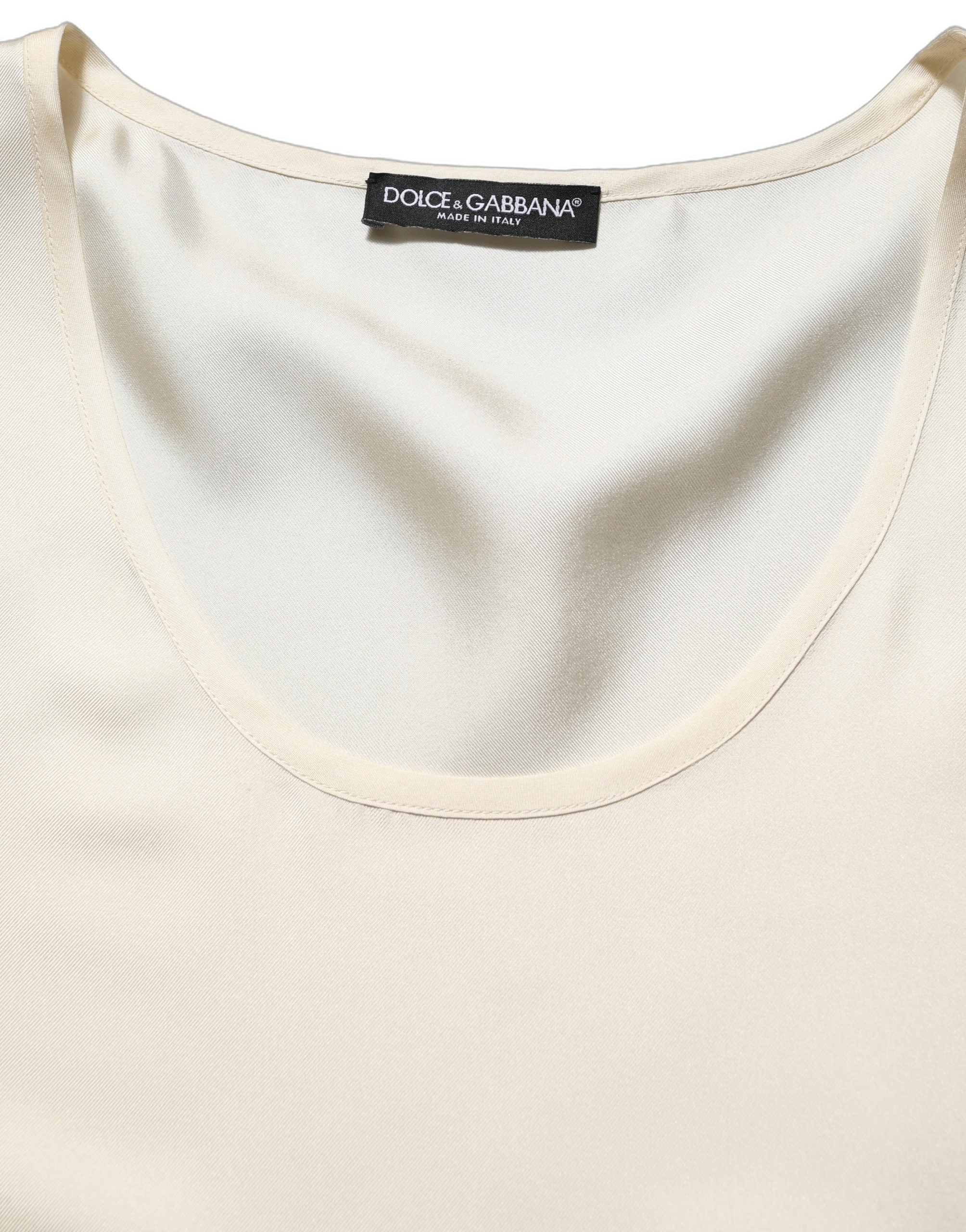 Indulge in the exquisite allure of Dolce & Gabbana's off-white silk tank top, a timeless piece reflecting Italian craftsmanship and effortless elegance for the discerning individual.