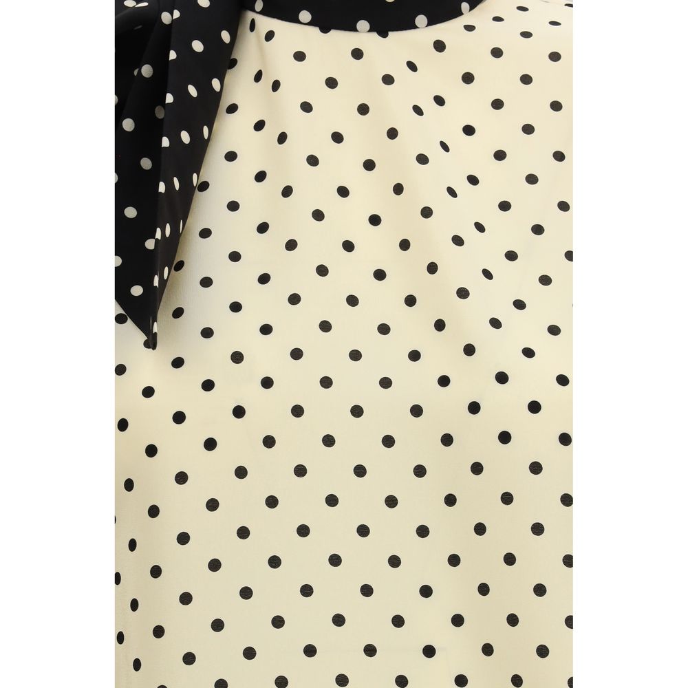 Indulge in the elegance of Valentino's Beige Silk Blouse, a masterpiece of 100% silk that embodies sophistication and timeless allure for the discerning connoisseur.
