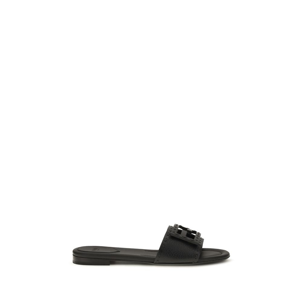 Elevate your style with Fendi's Black Calf Leather Bos Taurus Flat Sandals, a masterpiece of luxurious craftsmanship and contemporary elegance, perfect for any sophisticated occasion.